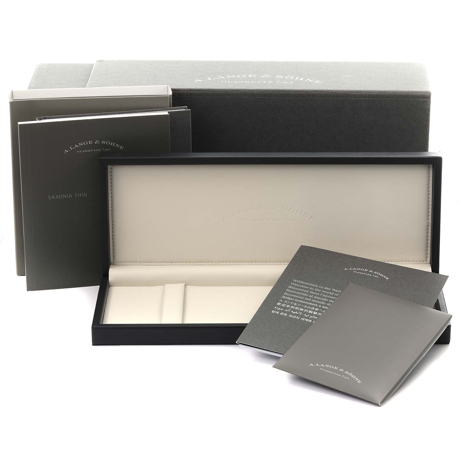 The image shows the A. Lange & Sohne Saxonia 205.086 Men's White Gold Blue Dial watch box and accessories, including manuals and a warranty card.