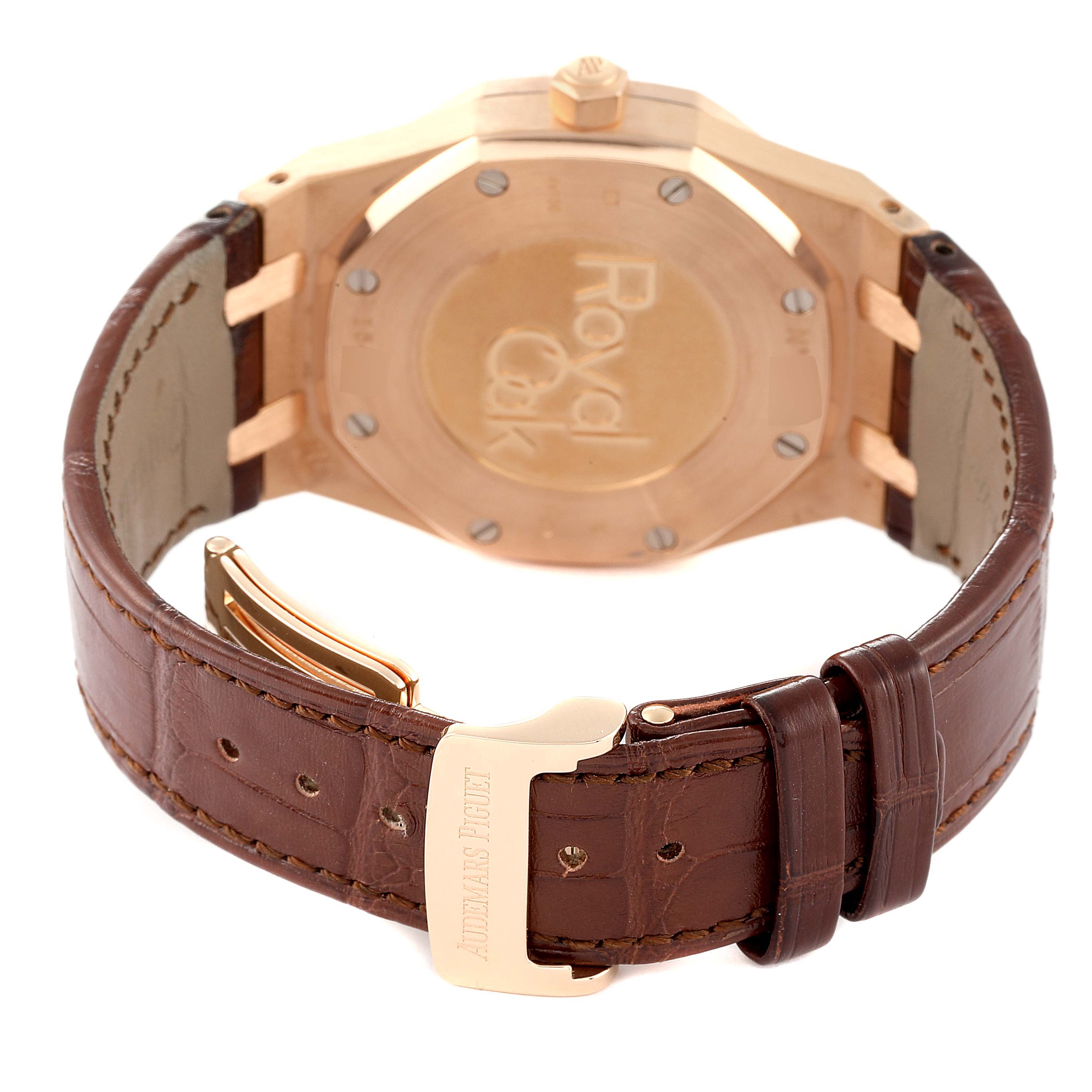 The image shows the back view of an Audemars Piguet Royal Oak 26120OR.00.D088CR.01 Men's Rose Gold Silver Dial 26120OR.00.D088CR.01 Men's Rose Gold Silver Dial watch, emphasizing the case back and the brown leather strap with a buckle.