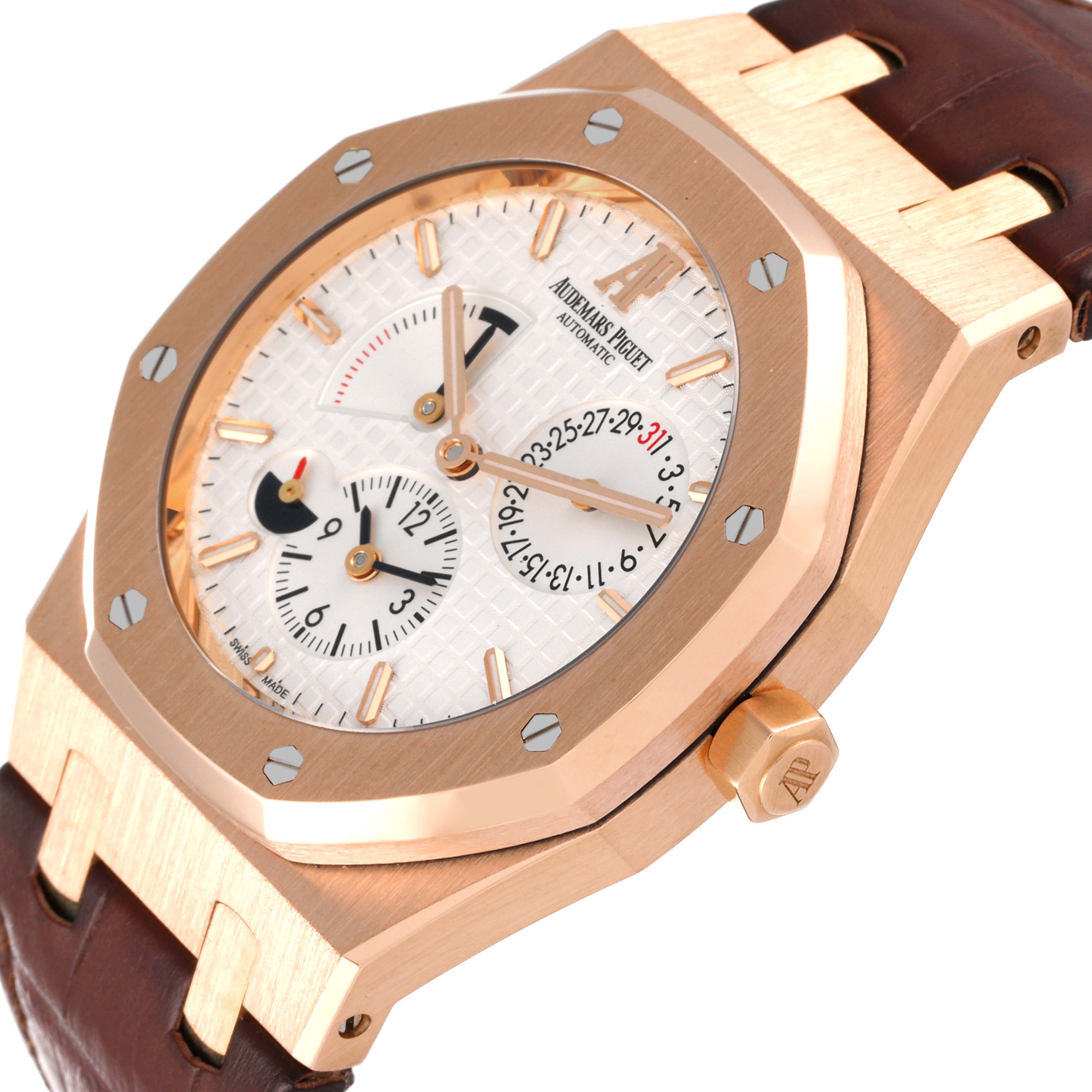 The Audemars Piguet Royal Oak 26120OR.00.D088CR.01 Men's Rose Gold Silver Dial 26120OR.00.D088CR.01 Men's Rose Gold Silver Dial watch is shown from an angled side view, displaying its face, bezel, crown, and leather strap.