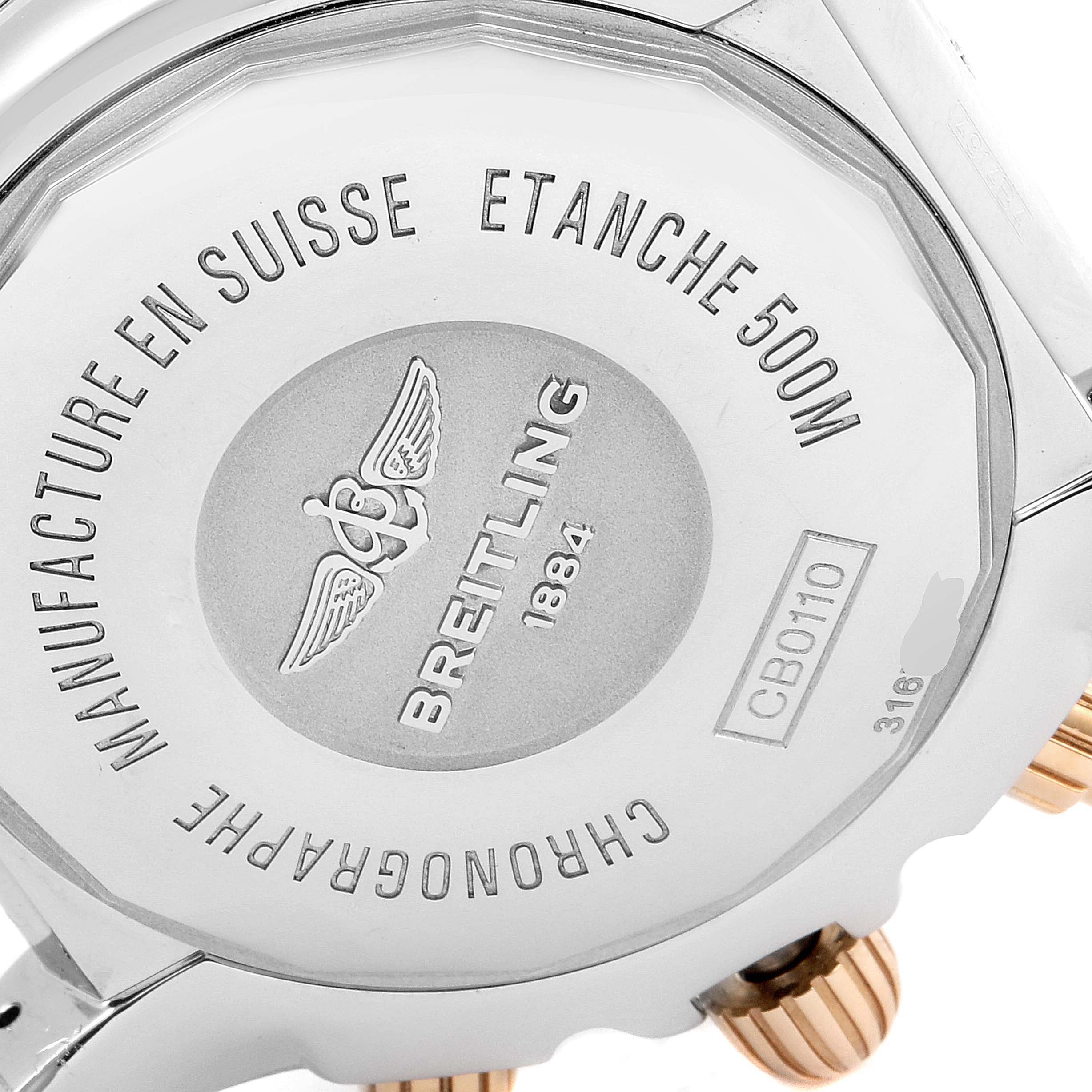 The image displays the back case of a Breitling Chronomat CB0110 Men's Rose Gold Black Dial CB0110 Men's Rose Gold Black Dial watch, highlighting its markings and details.