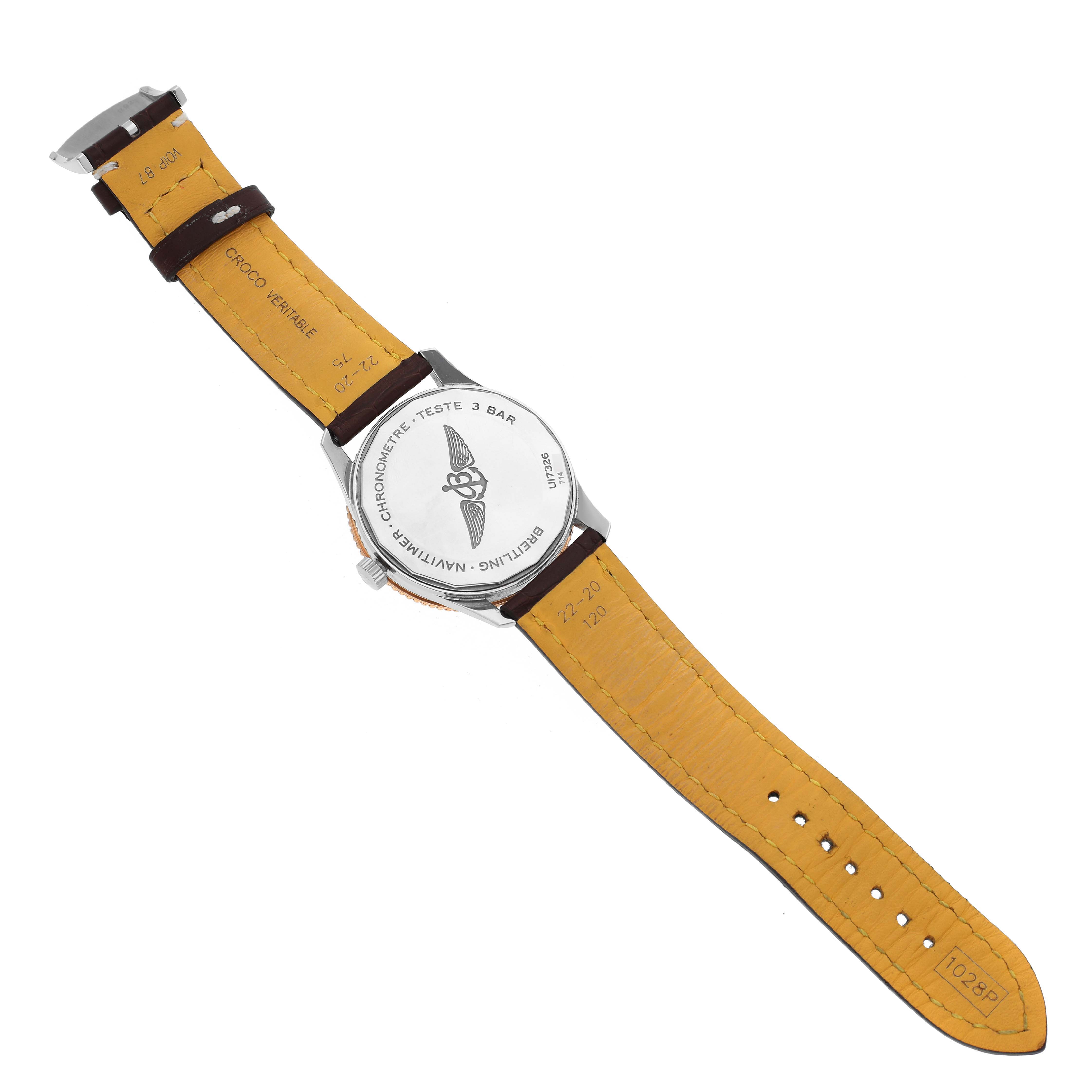 The image shows the back and strap of a Breitling Navitimer U17326 Men's Steel and Gold (two tone) Grey Dial U17326 Men's Steel and Gold (two tone) Grey Dial watch, highlighting the engravings on the case back and the interior of the leather strap.