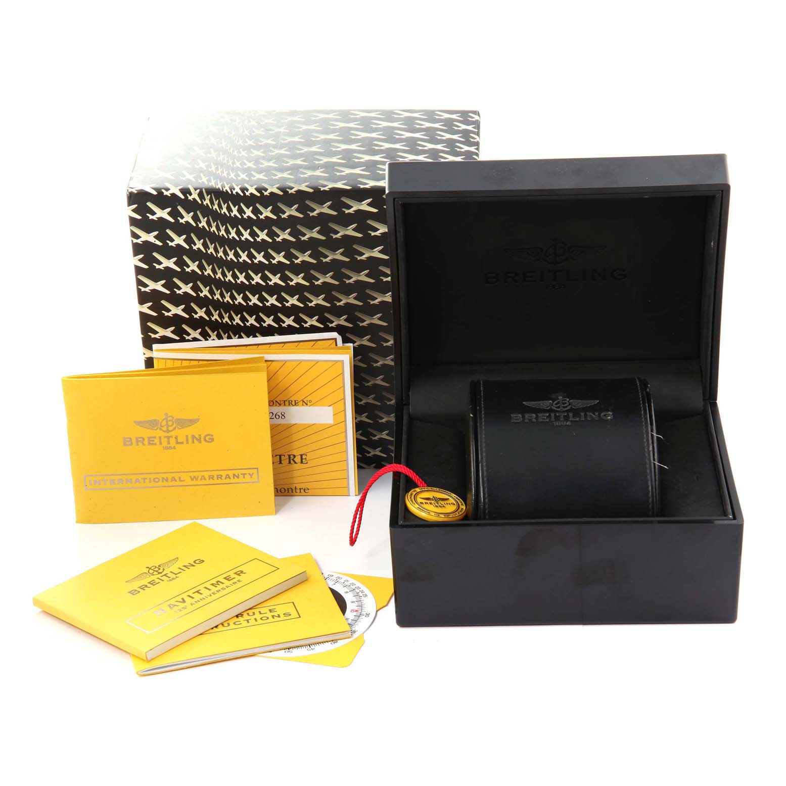 The image shows the packaging and accessories for a Breitling Navitimer A26322 Men's Stainless Steel Black Dial A26322 Men's Stainless Steel Black Dial, including the box, warranty, and manuals.