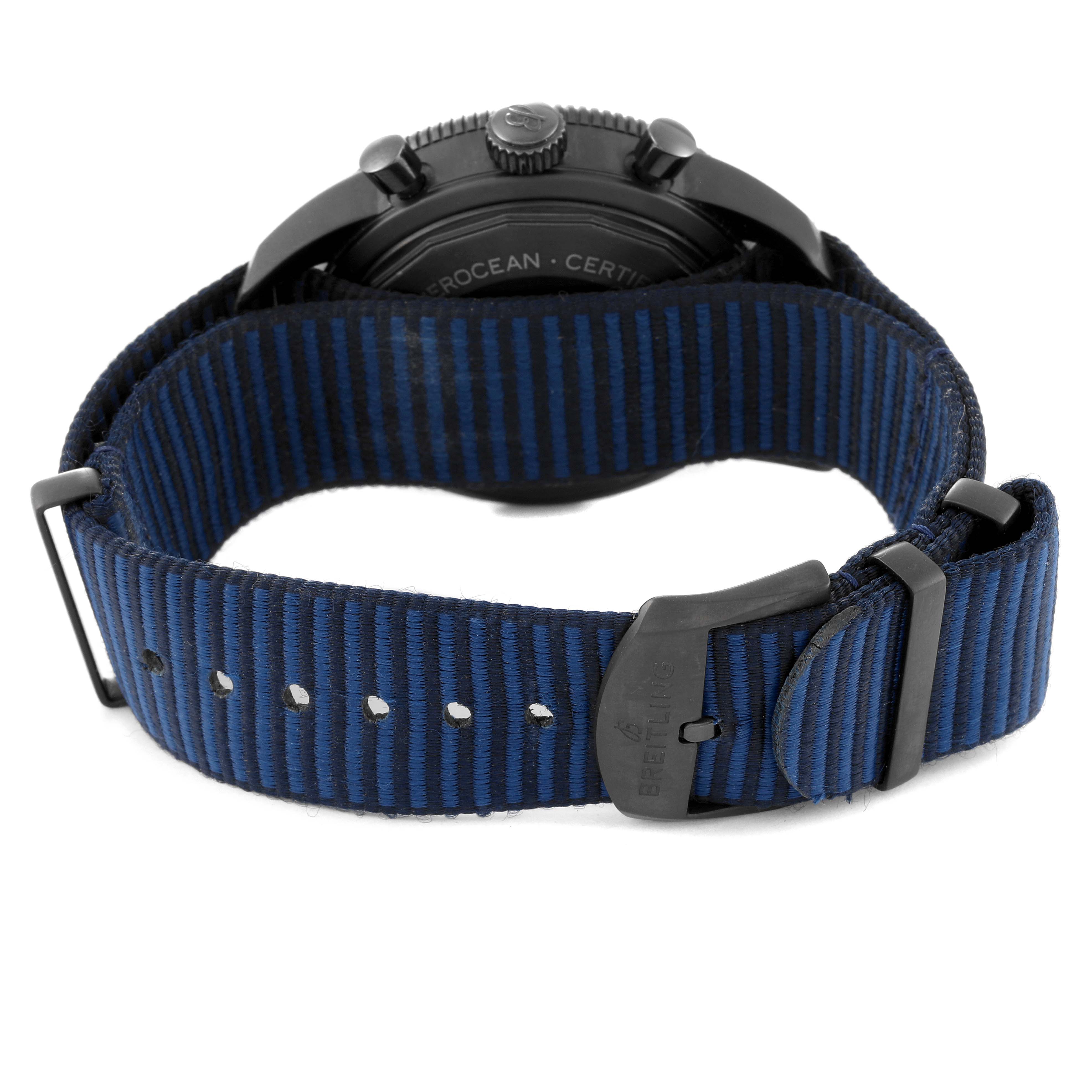 The image shows the back view of a Breitling Superocean M13313 Men's Stainless Steel Blue Dial M13313 Men's Stainless Steel Blue Dial watch with a blue and black striped fabric strap and black clasp.