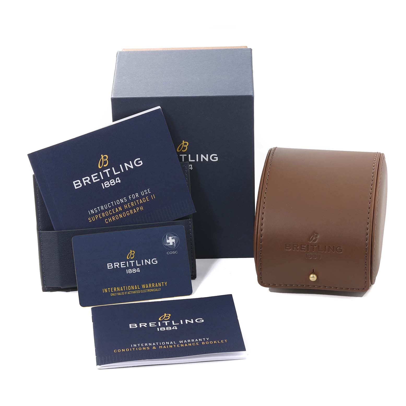 The image shows the accessories of a Breitling Superocean M13313 Men's Stainless Steel Blue Dial M13313 Men's Stainless Steel Blue Dial watch, including the box, warranty card, instructions, and a leather travel case.