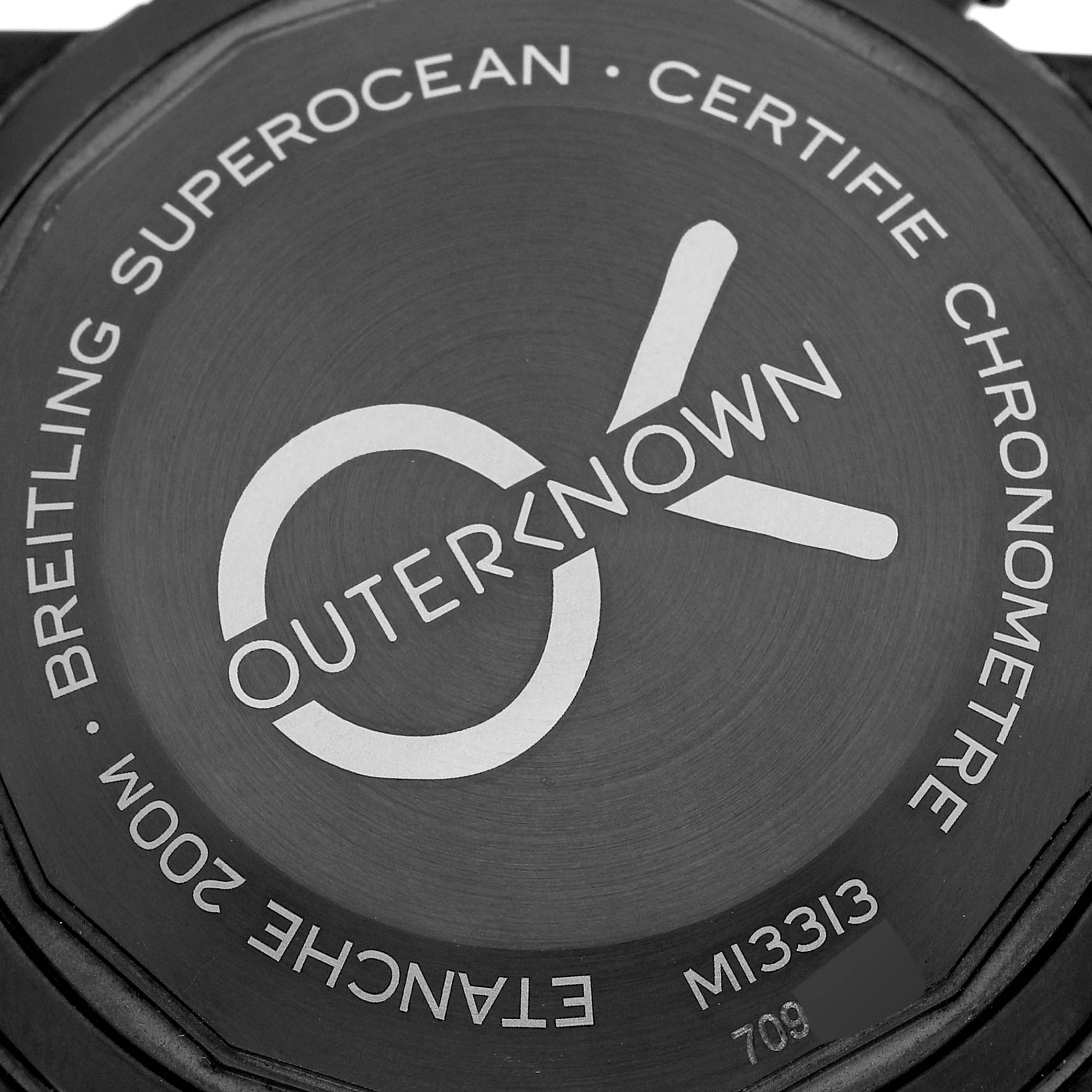The image shows the case back of a Breitling Superocean M13313 Men's Stainless Steel Blue Dial M13313 Men's Stainless Steel Blue Dial watch with "Outerknown" engraving and model information.