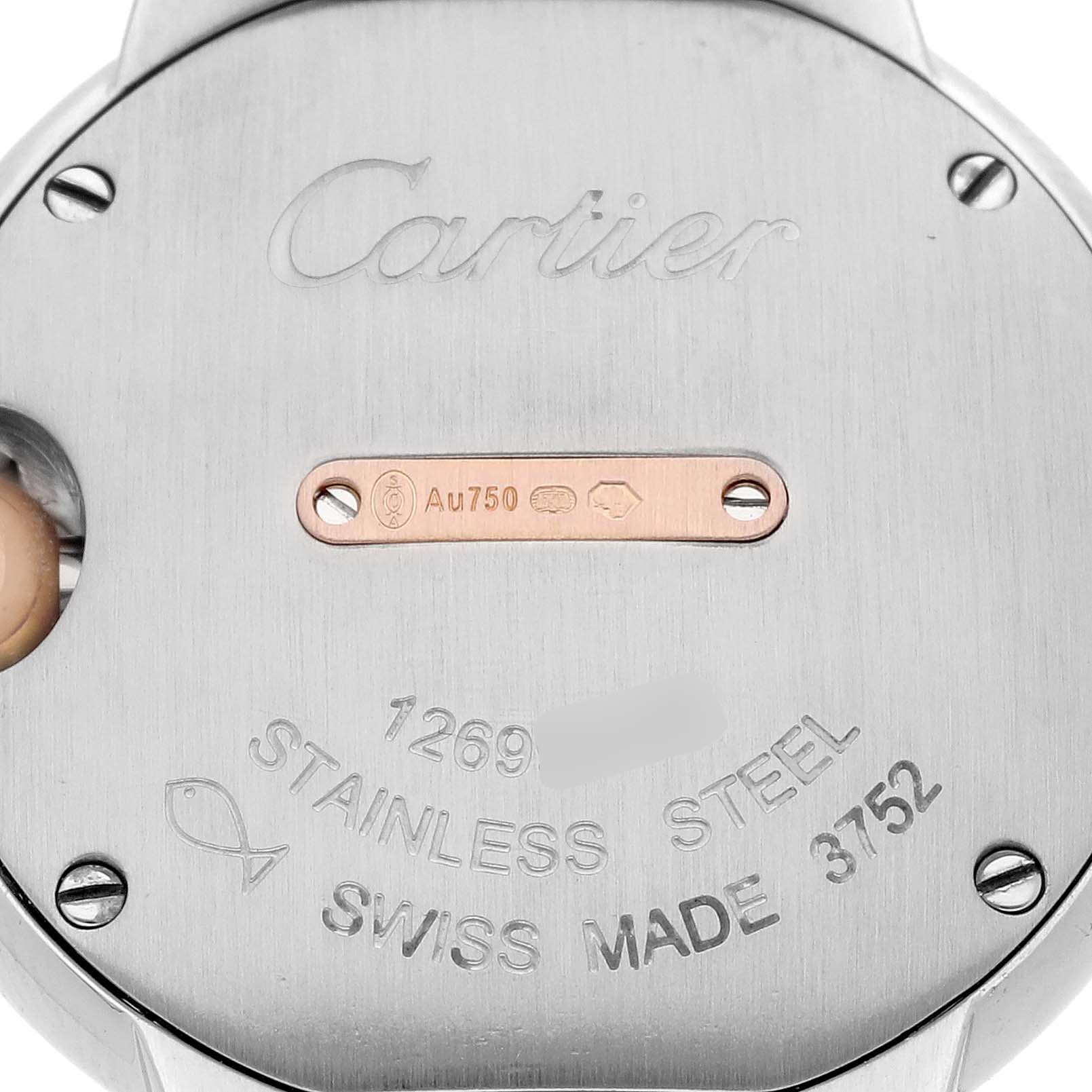 The image shows the back case of a Ballon Bleu de Cartier watch, featuring engravings and a metal hallmark.