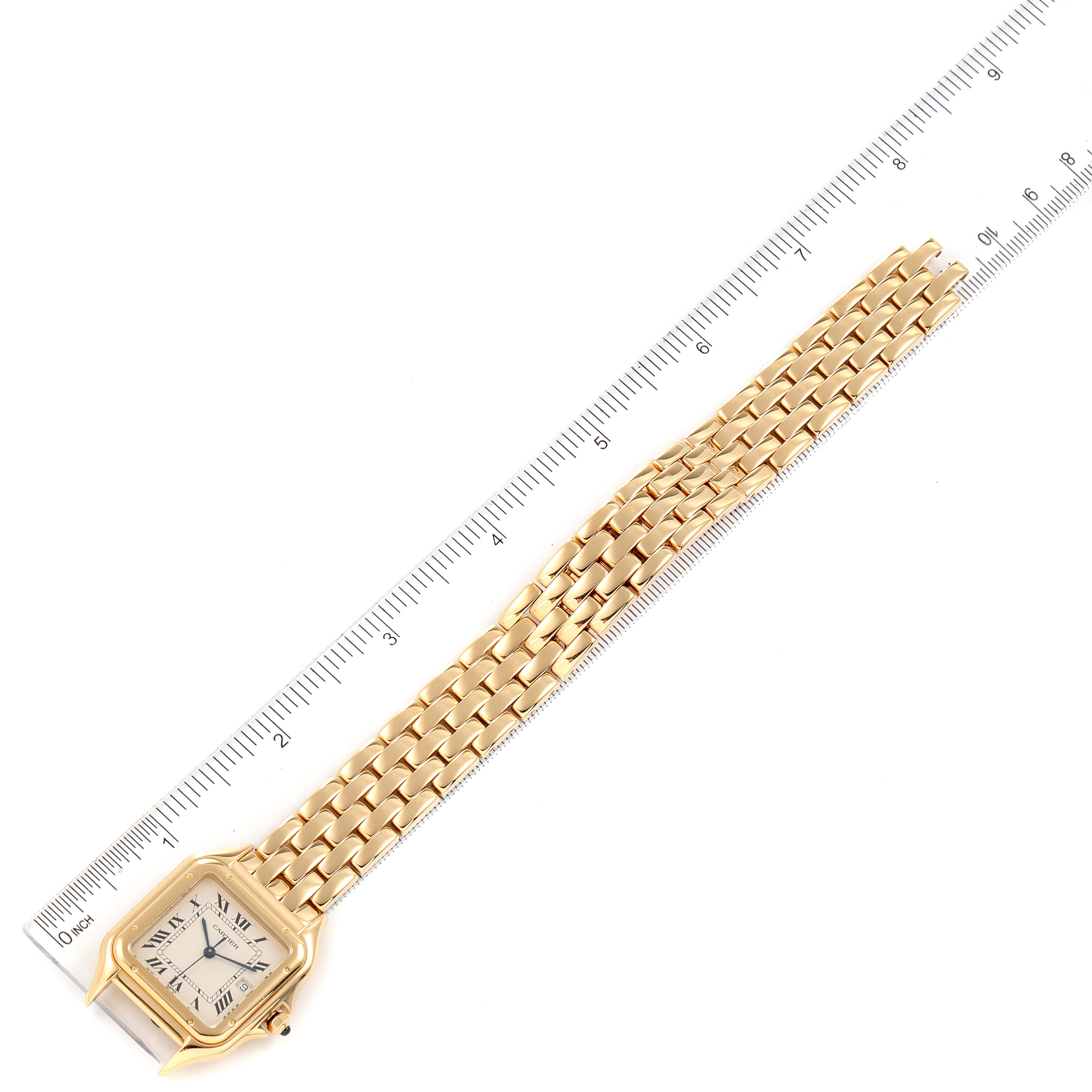 This image shows a Panthere de Cartier watch laid flat against a ruler, highlighting the face and full length of the bracelet.