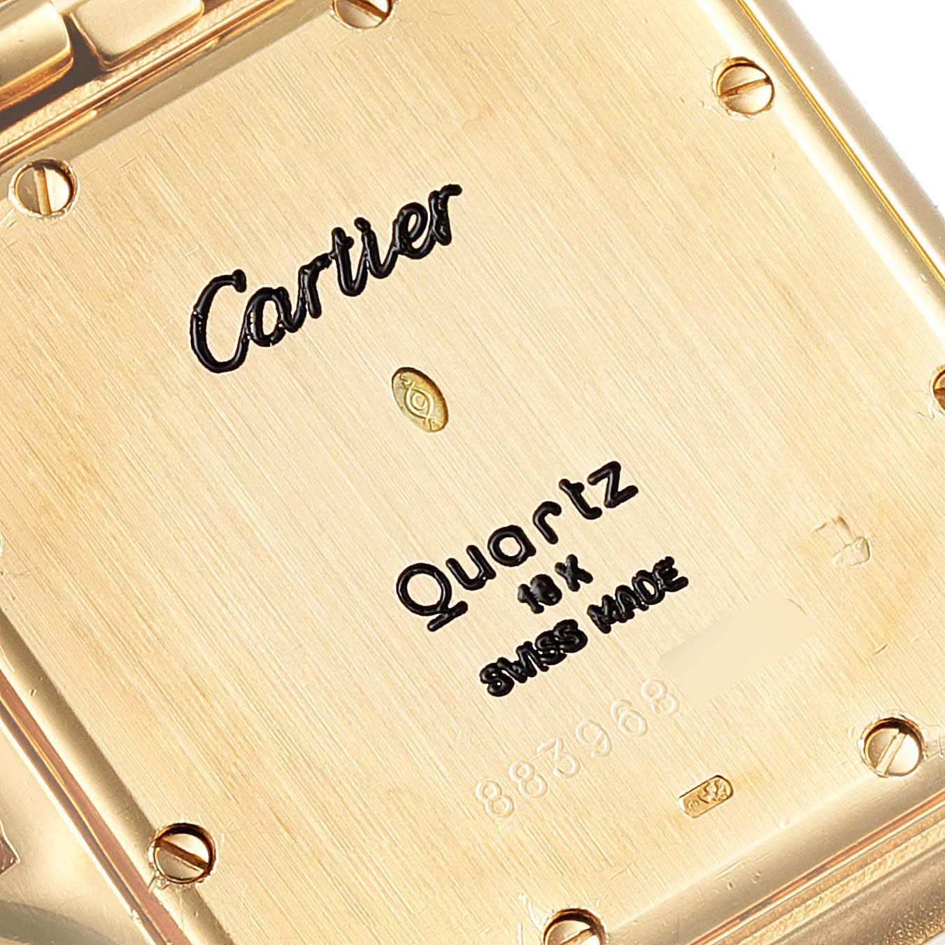 The image shows a close-up of the back casing of a Cartier Panthere W25014B9 Women's Yellow Gold Silver Dial W25014B9 Women's Yellow Gold Silver Dial Quartz watch, highlighting the engravings and screws.