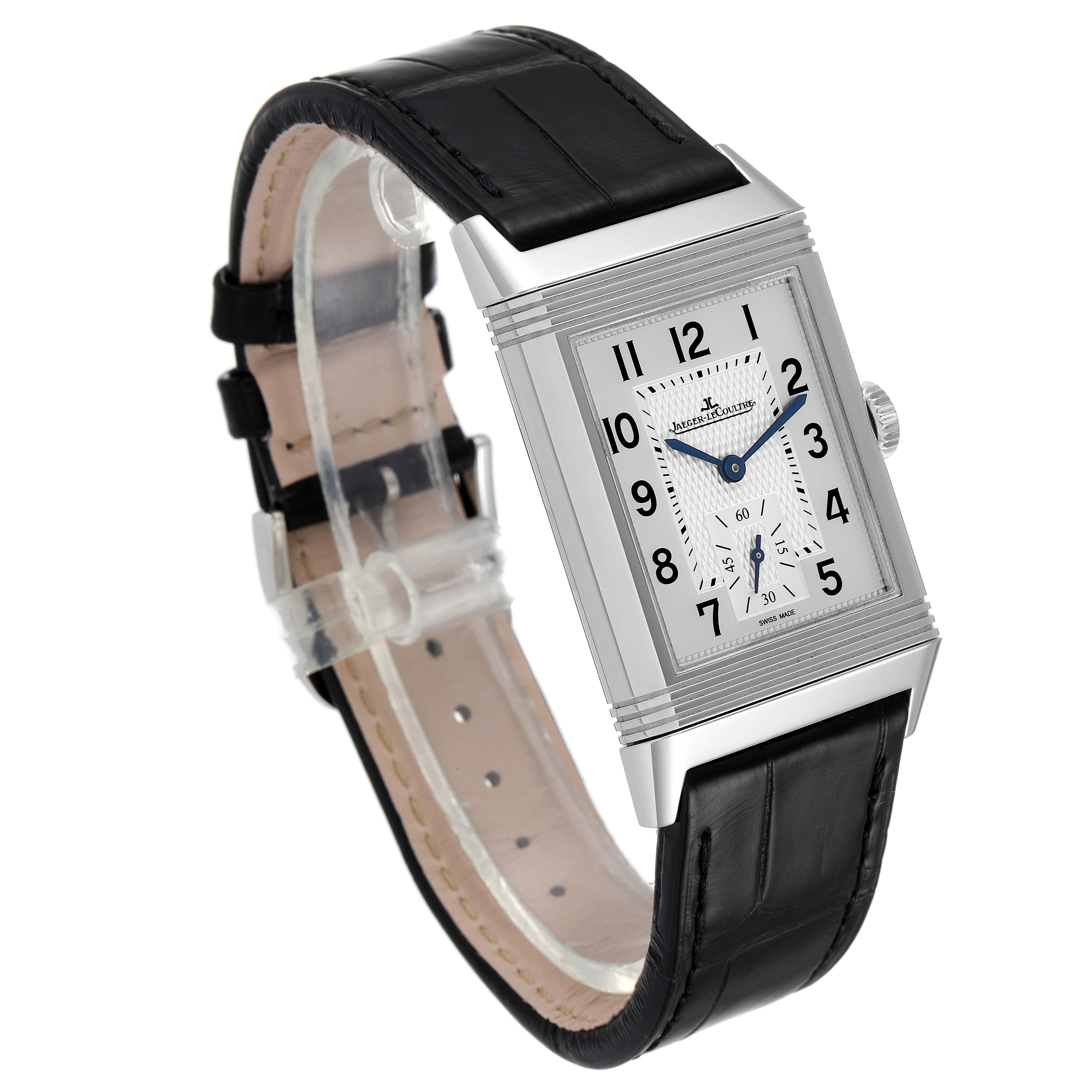 The Jaeger-LeCoultre Reverso model is shown at a three-quarter angle, revealing the dial, watch case, crown, and leather strap.