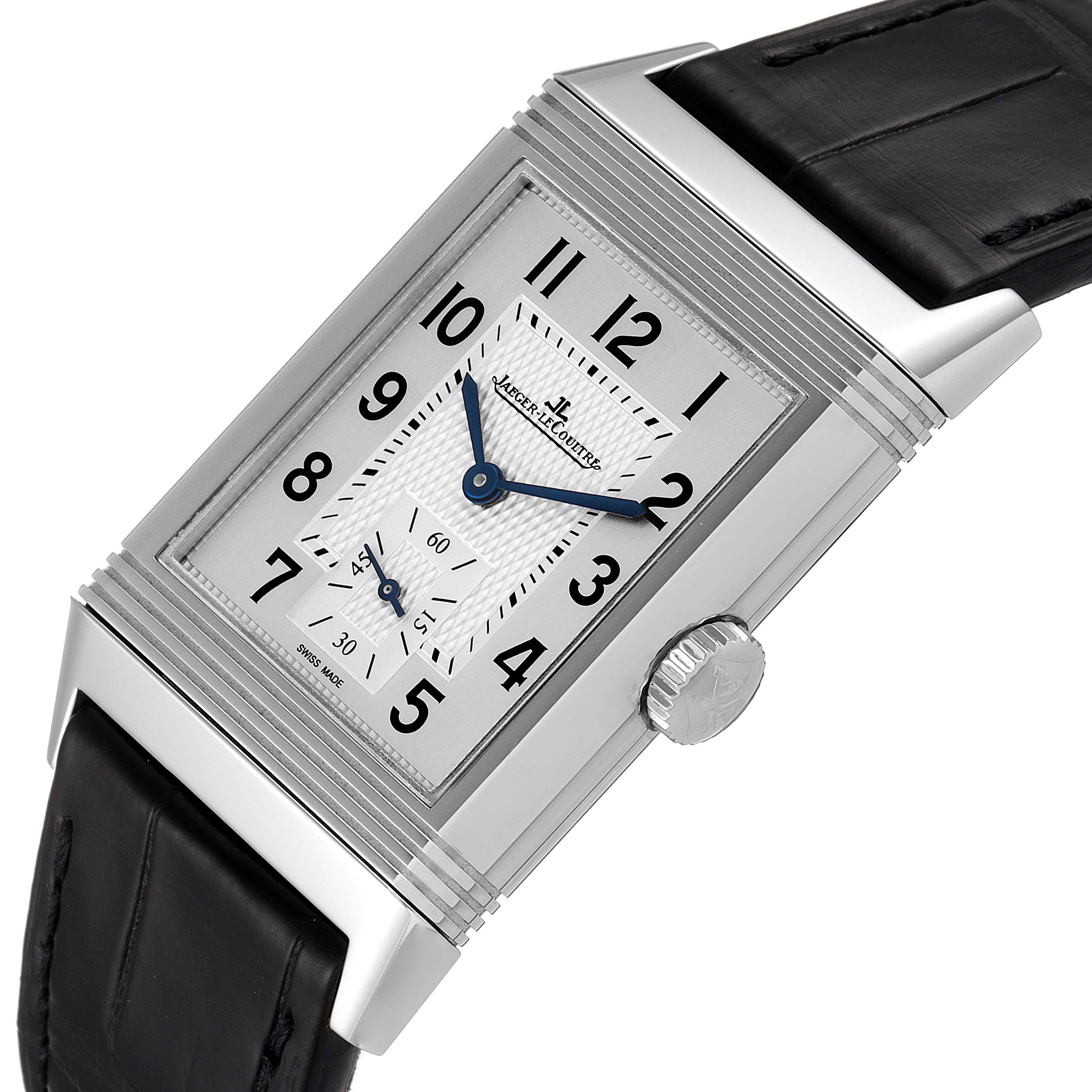 The Jaeger-LeCoultre Reverso watch is shown at an angled close-up, displaying the face, crown, and part of the leather strap.