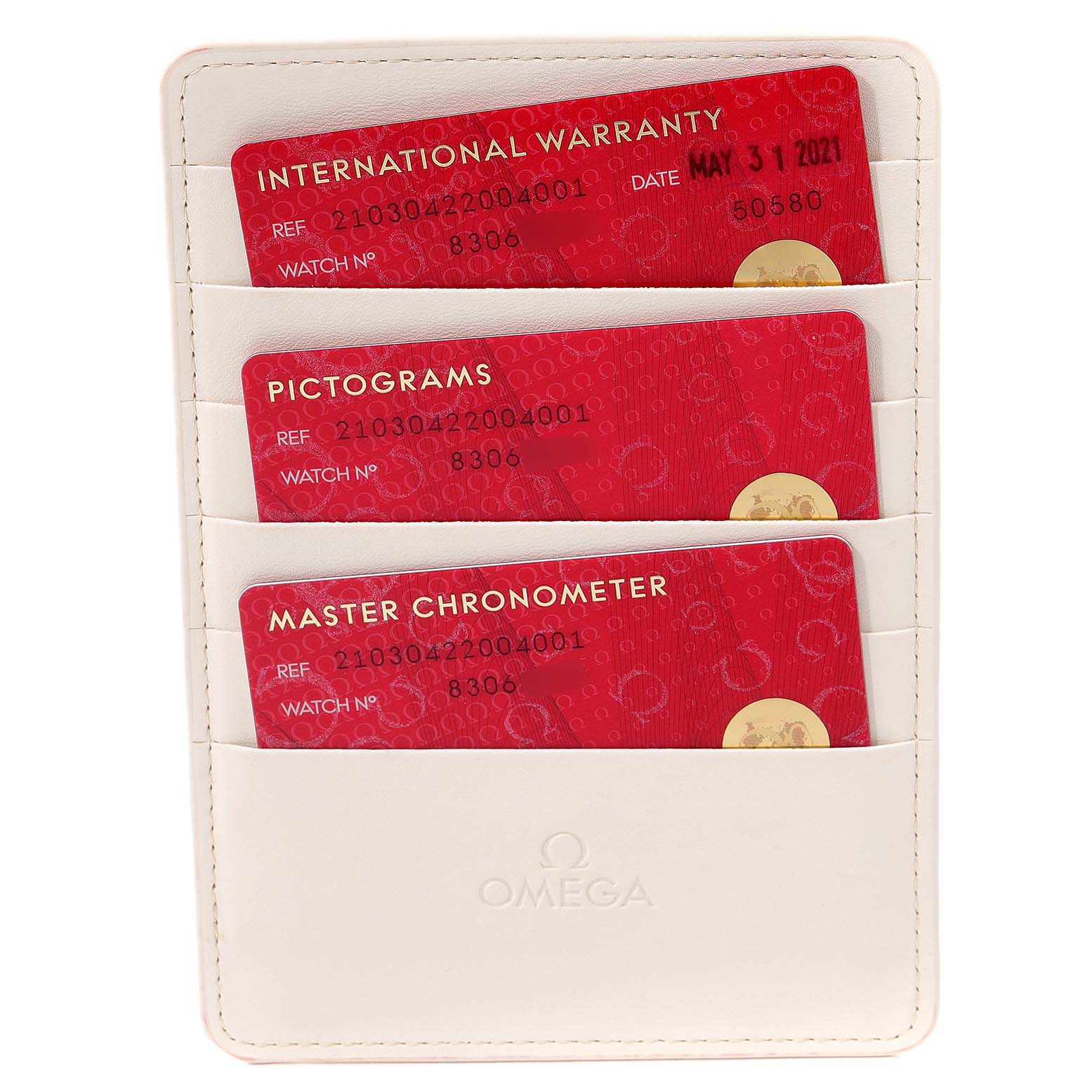 The image shows warranty and certification cards in a white Omega holder for the Seamaster model watch.