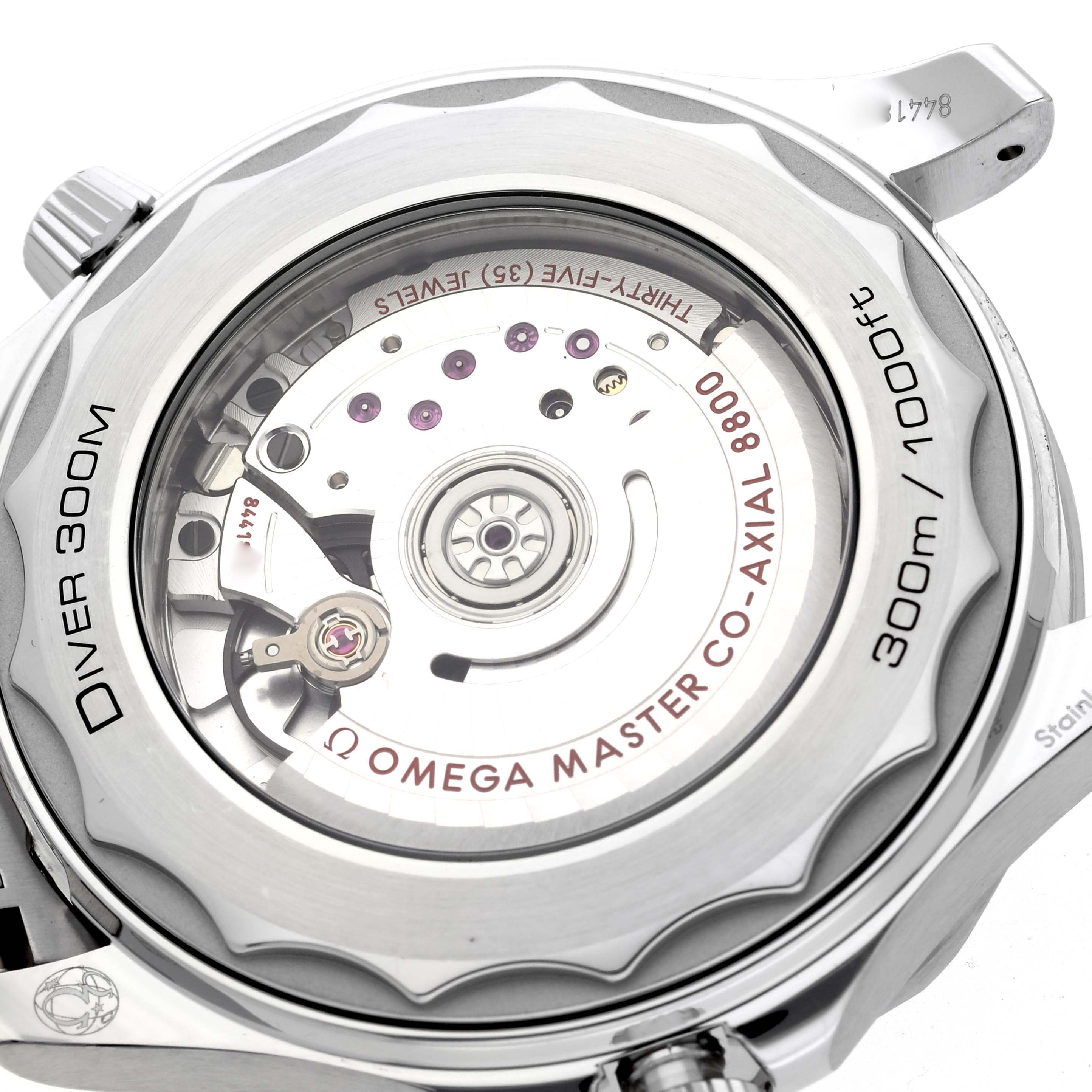 The image shows the back view of an Omega Seamaster 210.30.42.20.10.001 Men's Stainless Steel Green Dial 210.30.42.20.10.001 Men's Stainless Steel Green Dial, highlighting its co-axial movement and 300m water resistance.