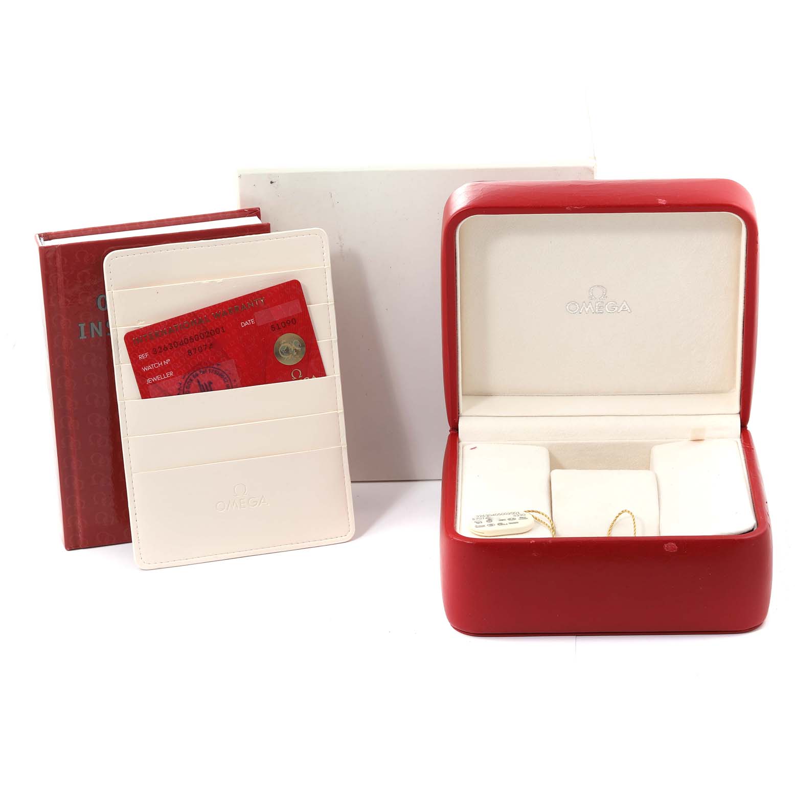 The image shows a red Omega box for the Speedmaster model along with its instruction manual and warranty cards.