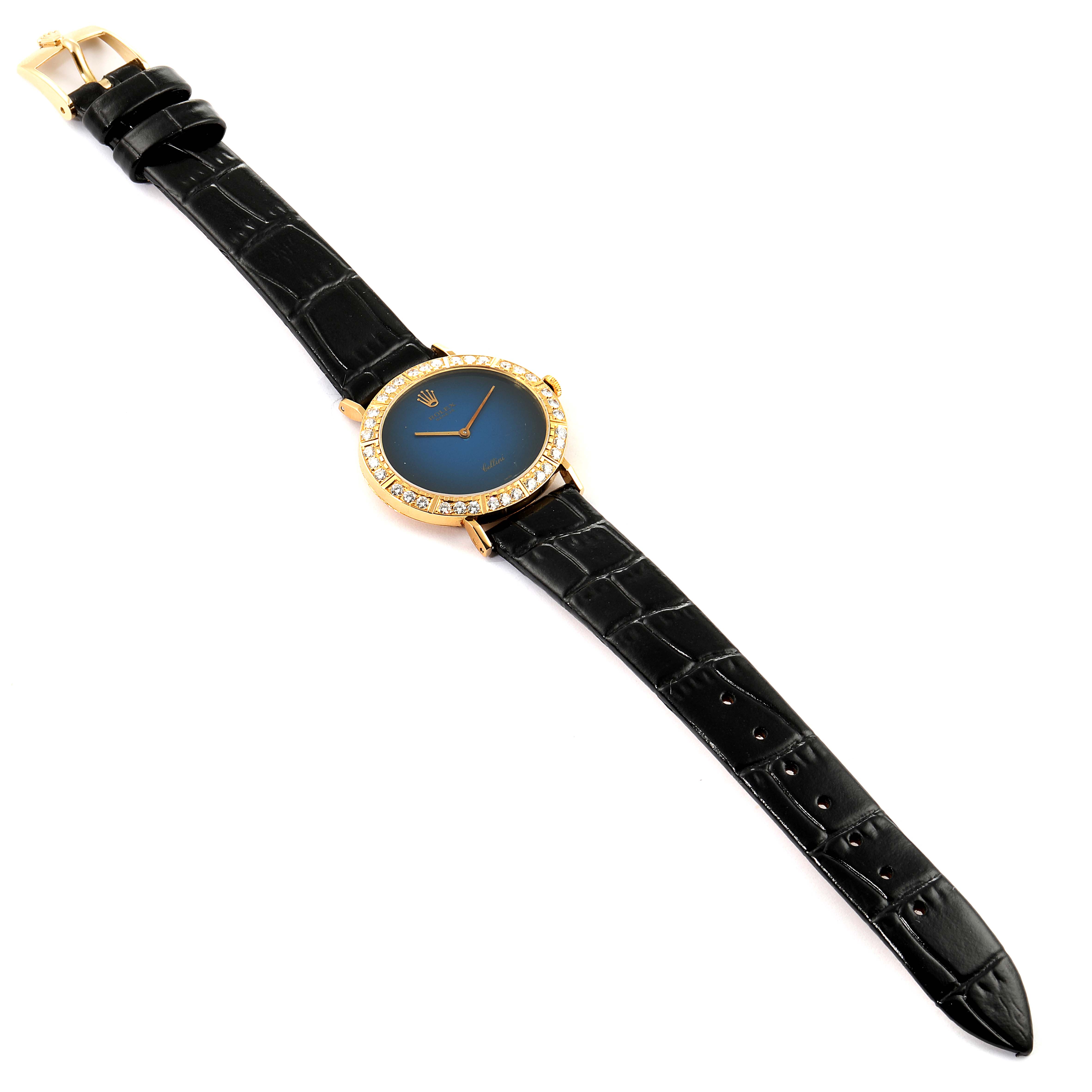 The image shows a Rolex Cellini 4083 Women's Yellow Gold Blue Dial 4083 Women's Yellow Gold Blue Dial watch from a slightly angled top-down perspective, displaying the black strap, blue dial, and gold case with diamond bezel.