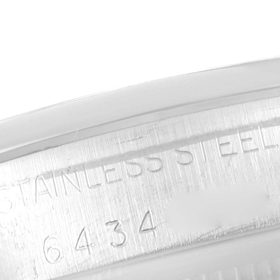 This close-up image shows the stainless steel engraving and partial serial number on the case of a Rolex Vintage Collection 1500 Men's Stainless Steel Silver Dial 1500 Men's Stainless Steel Silver Dial model.