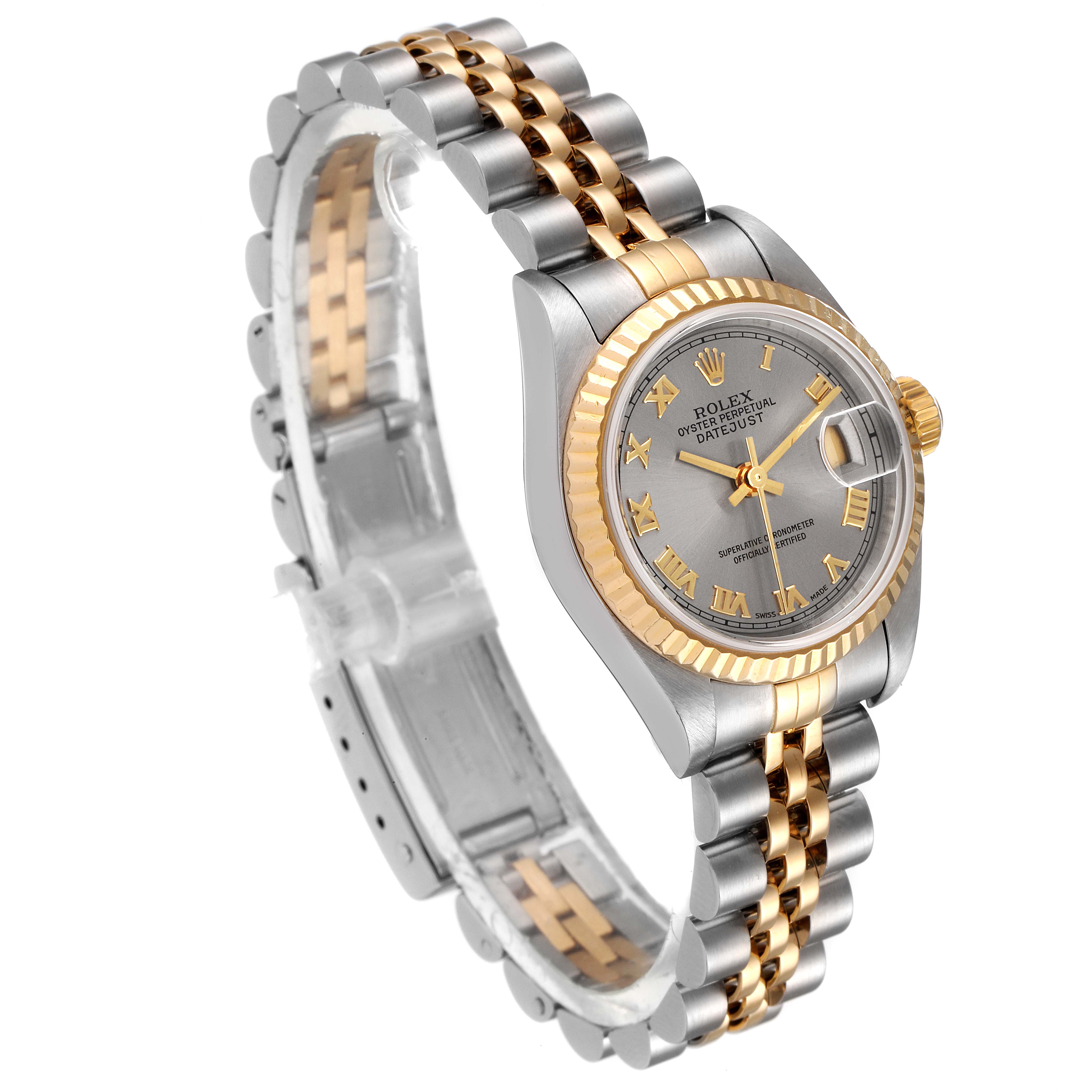 This Rolex Datejust 79173 Women
s Steel and Gold (two tone) Grey Dial 79173 Women
s Steel and Gold (two tone) Grey Dial watch is pictured at an oblique angle, showcasing its jubilee bracelet, fluted bezel, and roman numeral dial.
