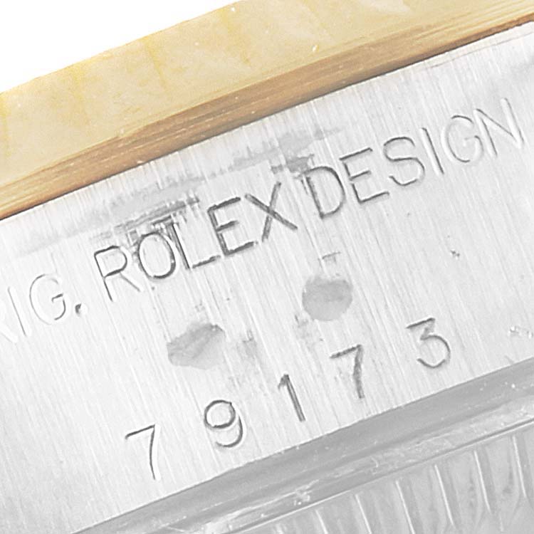 This image shows a close-up of the case side of a Rolex Datejust 79173 Women
s Steel and Gold (two tone) Grey Dial 79173 Women
s Steel and Gold (two tone) Grey Dial watch with the model number engraved.