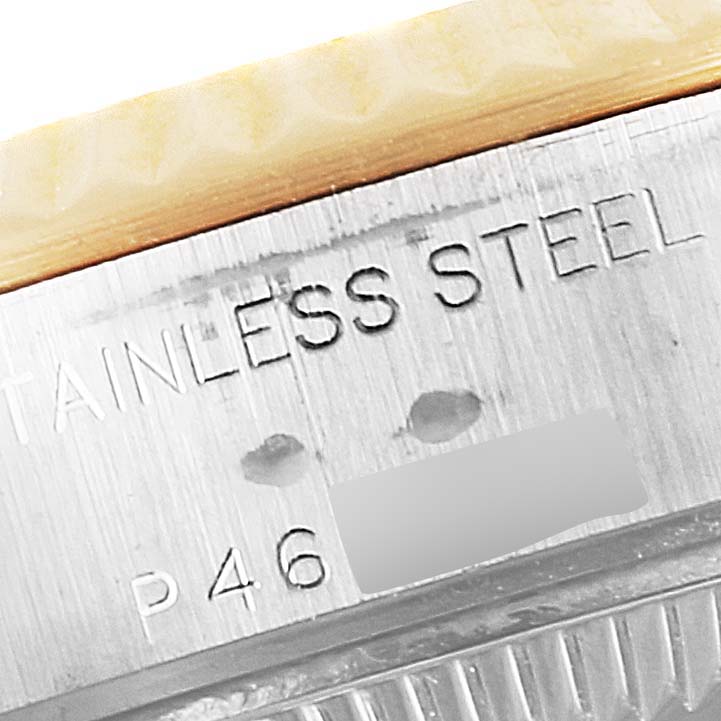 The image shows a close-up of the stainless steel case back and grooved bezel of a Rolex Datejust 79173 Women
s Steel and Gold (two tone) Grey Dial 79173 Women
s Steel and Gold (two tone) Grey Dial watch.