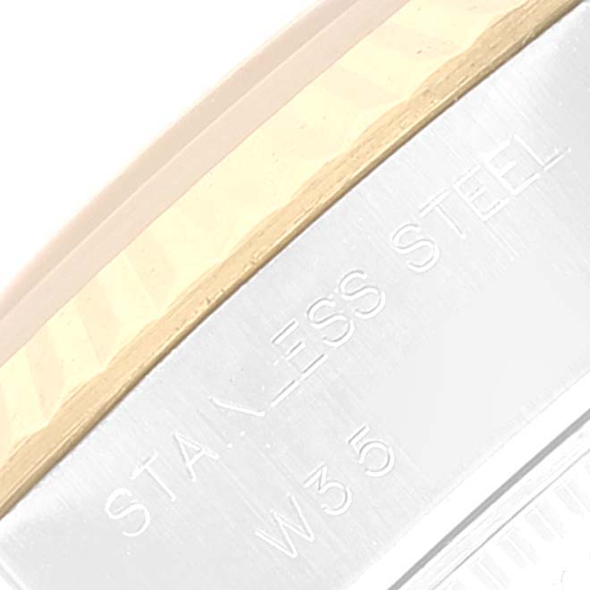 This image shows a close-up view of the side of a Rolex Datejust 69173 Women's Steel and Gold (two tone) Blue Dial 69173 Women's Steel and Gold (two tone) Blue Dial model, highlighting the engraving and part of the bezel.