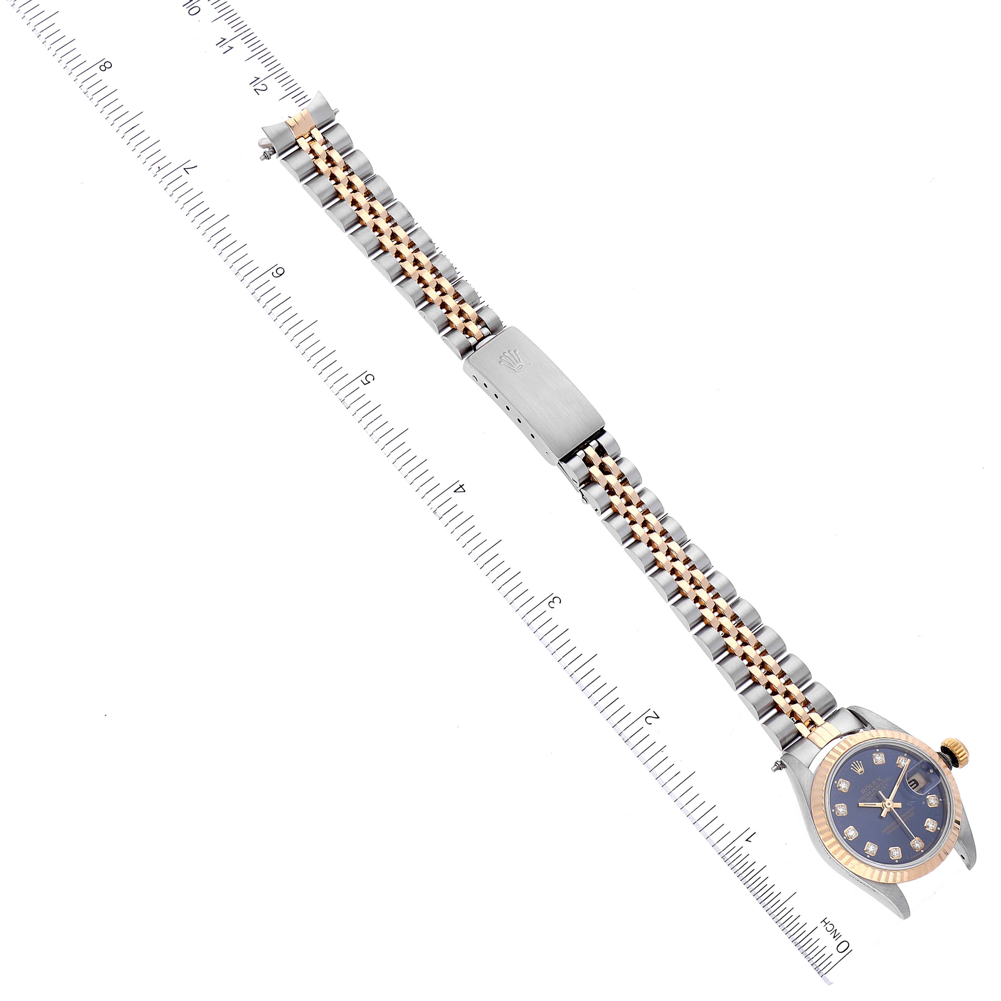 The Rolex Datejust 69173 Women's Steel and Gold (two tone) Blue Dial 69173 Women's Steel and Gold (two tone) Blue Dial watch is displayed from a top-down angle, showing the full bracelet, clasp, and watch face.