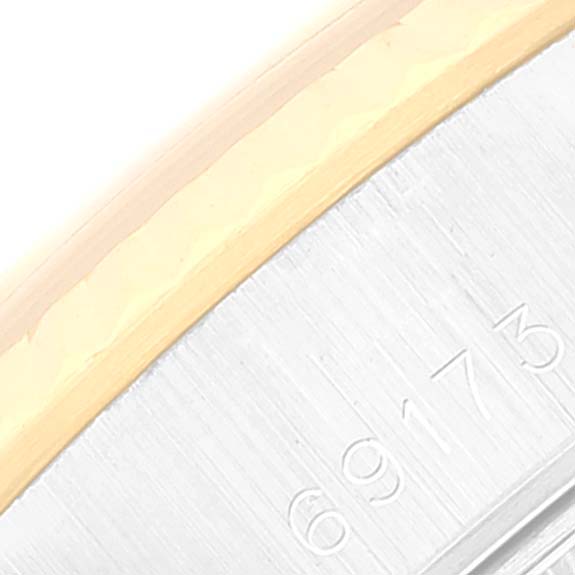 The image shows a close-up of the side engraving and the gold edge of a Rolex Datejust 69173 Women's Steel and Gold (two tone) Champagne Dial 69173 Women's Steel and Gold (two tone) Champagne Dial watch.