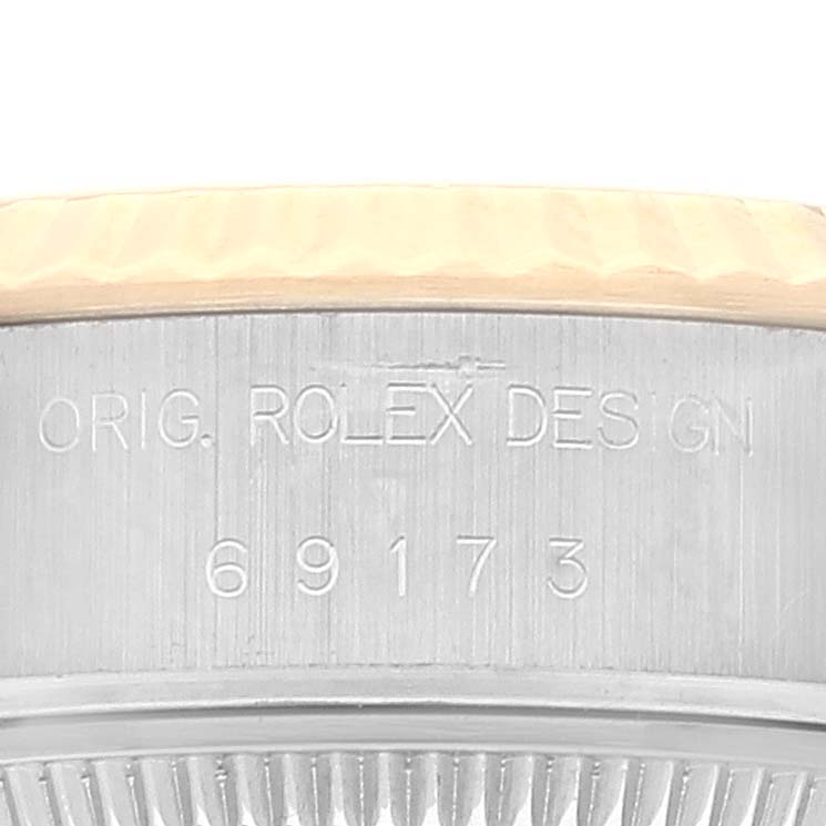The image shows a close-up of the side and part of the bezel of a Rolex Datejust 69173 Women's Steel and Gold (two tone) Champagne Dial 69173 Women's Steel and Gold (two tone) Champagne Dial model, with the inscription "ORIG. ROLEX DESIGN" and "69173".