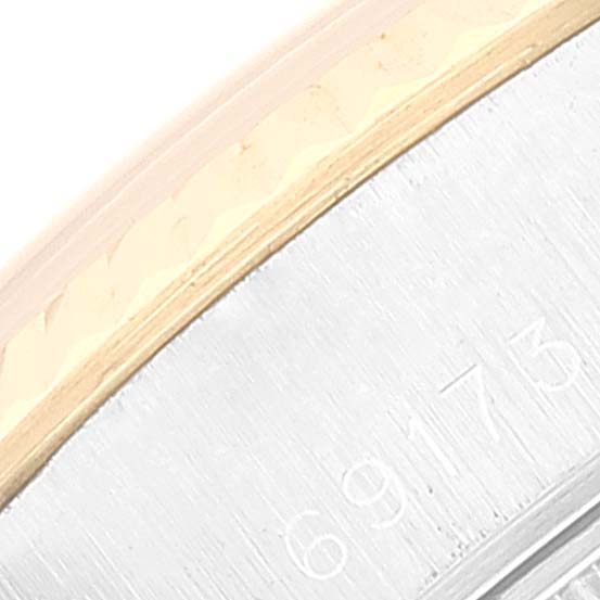 This close-up image shows the bezel and part of the case side of a Rolex Datejust 69173 Women's Steel and Gold (two tone) White Dial 69173 Women's Steel and Gold (two tone) White Dial watch.