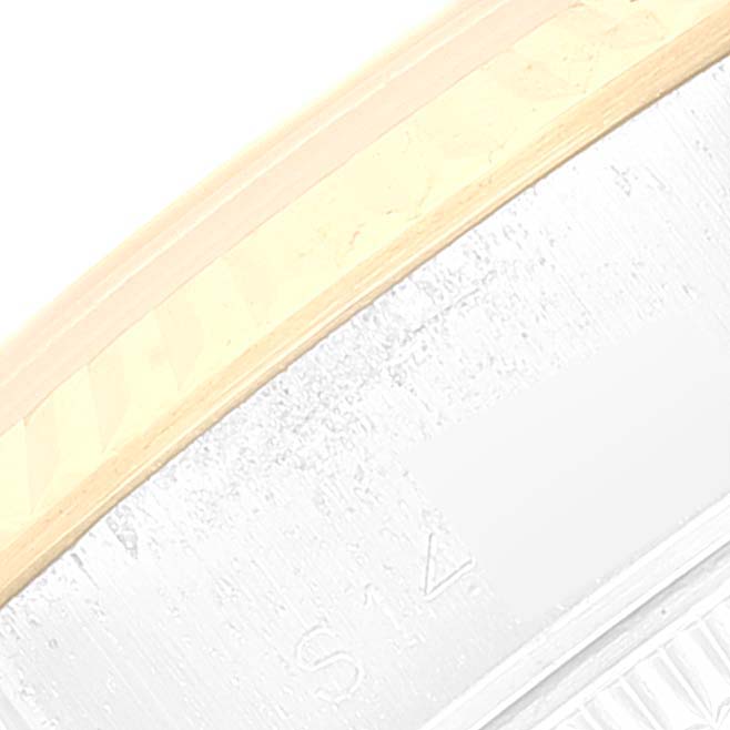 This close-up image shows part of the bezel and side of the case of a Rolex Datejust 69173 Women's Steel and Gold (two tone) White Dial 69173 Women's Steel and Gold (two tone) White Dial watch.