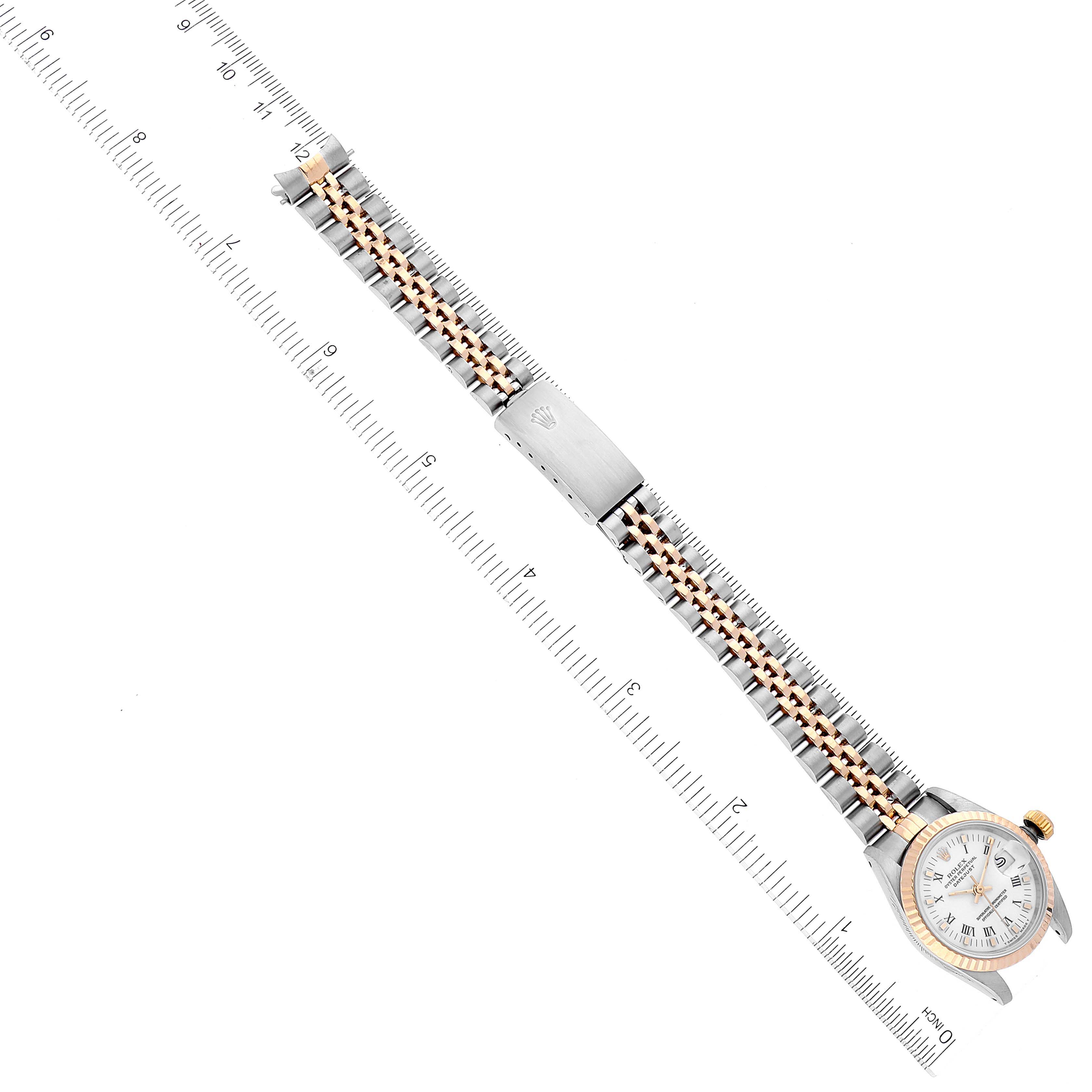 The image shows a Rolex Datejust 69173 Women's Steel and Gold (two tone) White Dial 69173 Women's Steel and Gold (two tone) White Dial watch from a top-down angle, displaying its dial, bezel, and two-tone metal bracelet against a ruler background.