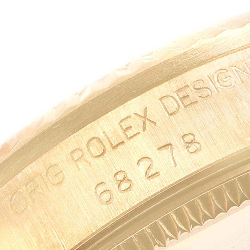 The image shows a close-up of the side of a Rolex President 68278 Women's Yellow Gold Champagne Dial 68278 Women's Yellow Gold Champagne Dial watch case with engraved model numbers.