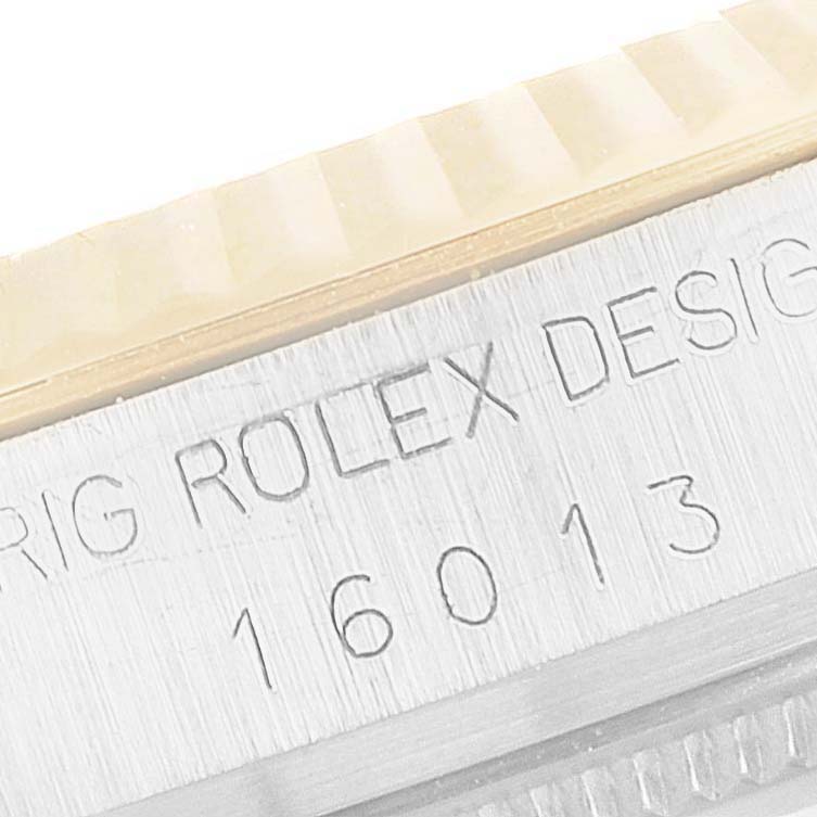 This is a close-up angle of the side engraving on the bezel of a Rolex Vintage Collection 16013 Men's Steel and Gold (two tone) Champagne Dial 16013 Men's Steel and Gold (two tone) Champagne Dial model 16013 watch.