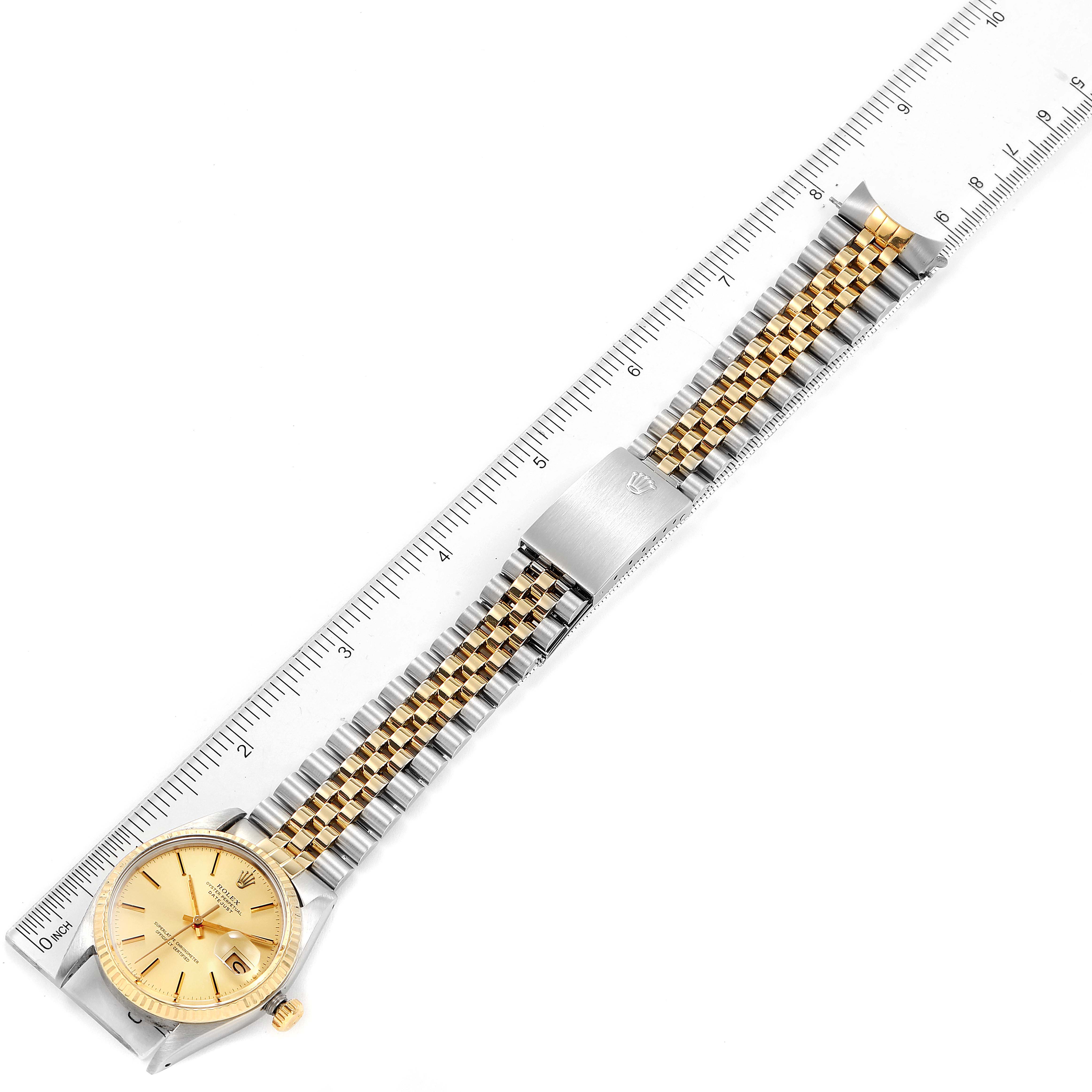 The image shows a top view of a Rolex Vintage Collection 16013 Men's Steel and Gold (two tone) Champagne Dial 16013 Men's Steel and Gold (two tone) Champagne Dial watch, including the watch face, crown, and full bracelet, alongside a ruler.