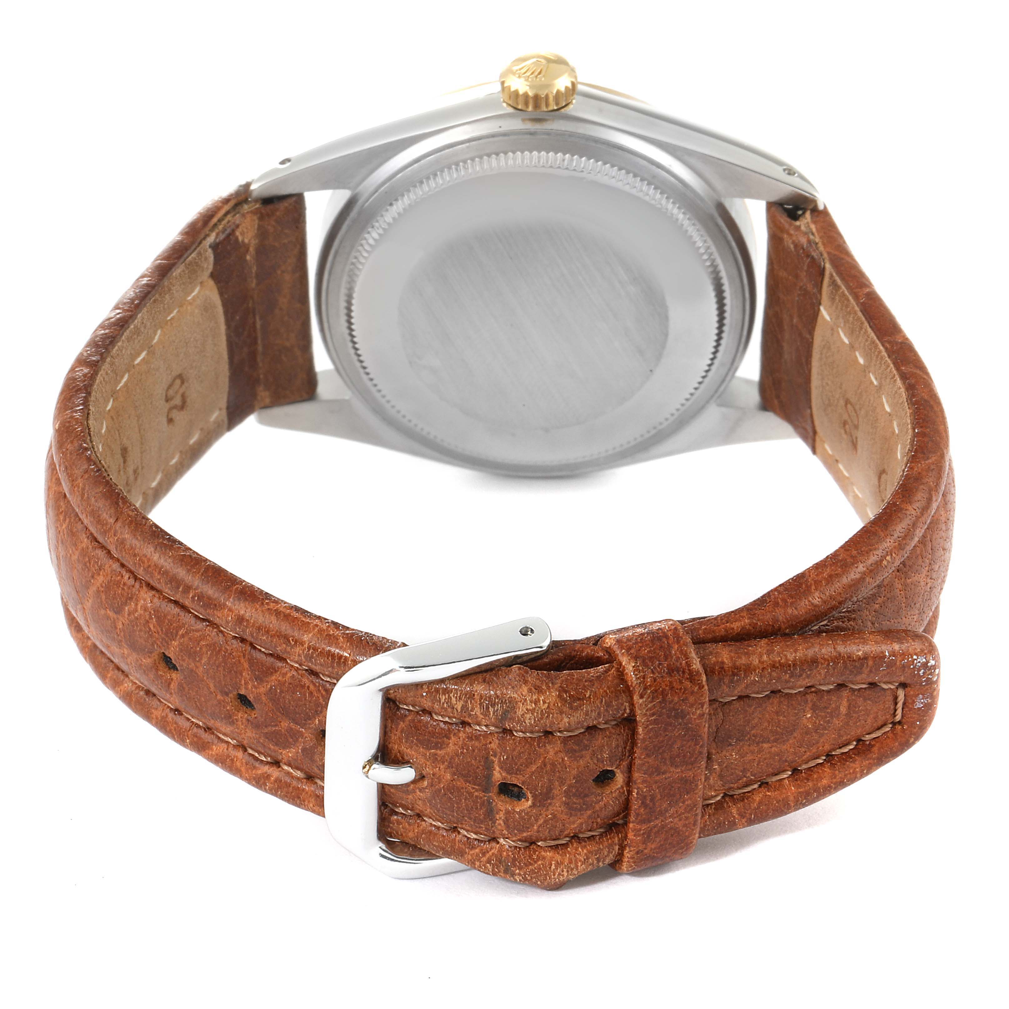 The image shows the back view of the Rolex Vintage Collection 16013 Men
s Steel and Gold (two tone) Champagne Dial 16013 Men
s Steel and Gold (two tone) Champagne Dial watch with a brown leather strap and metal buckle.