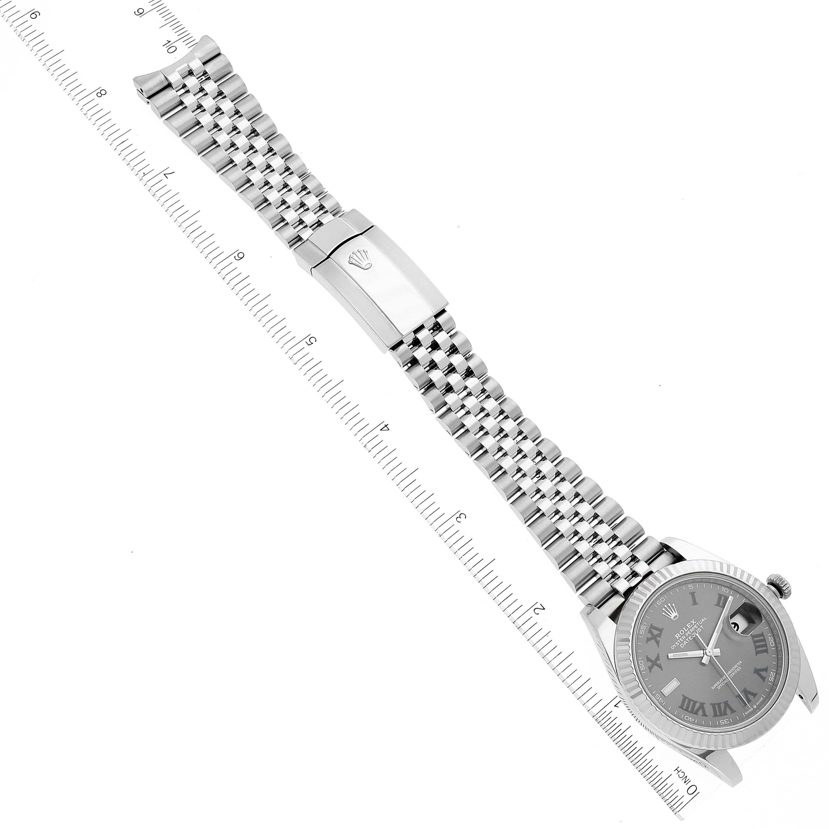 This image shows a Datejust 41 Rolex watch lying flat, with its bracelet, clasp, dial, and case visible next to a ruler for scale.