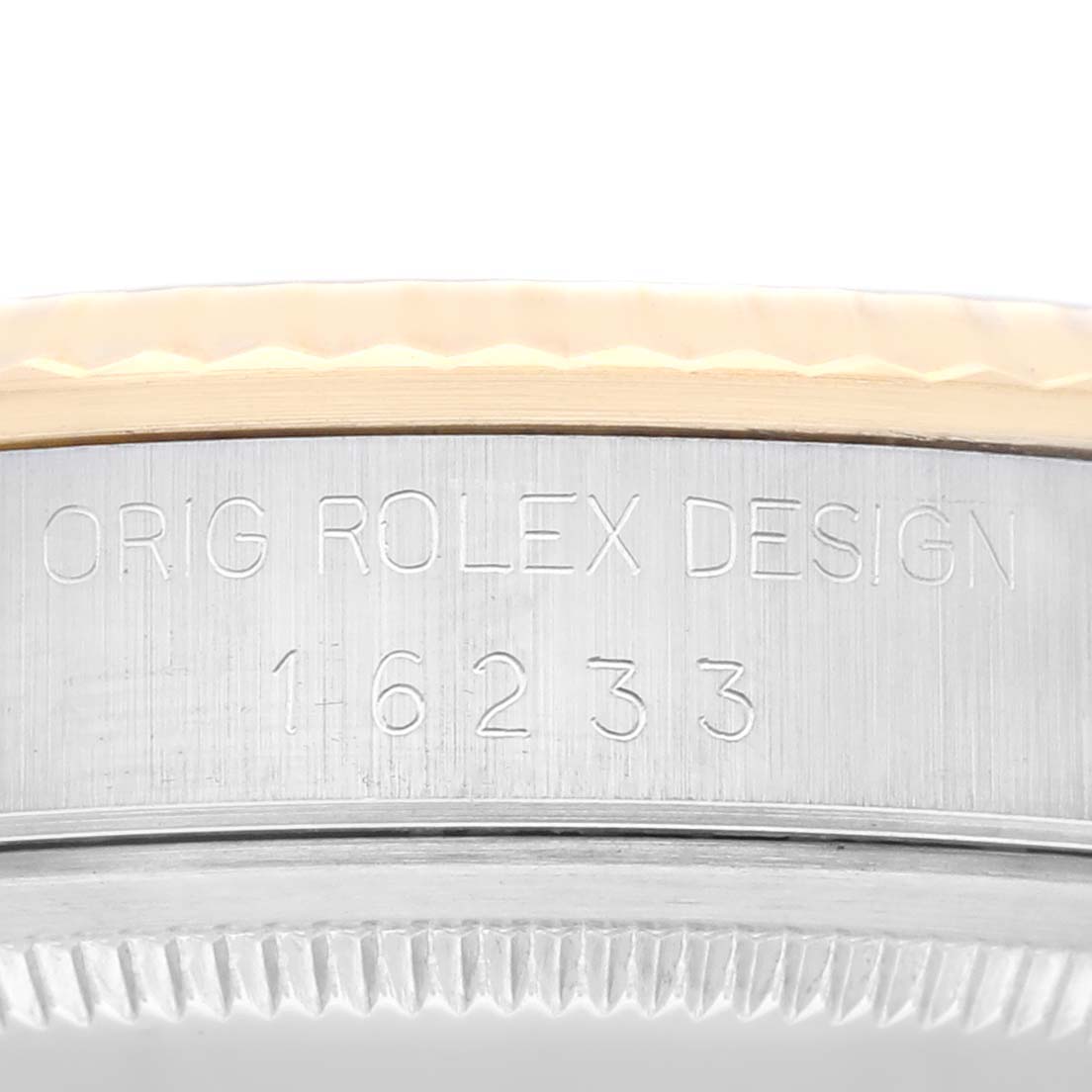 This image shows a close-up of the side of a Rolex Datejust 16233 Men's Steel and Gold (two tone) Champagne Dial 16233 Men's Steel and Gold (two tone) Champagne Dial model, displaying its bezel and engraved design number.