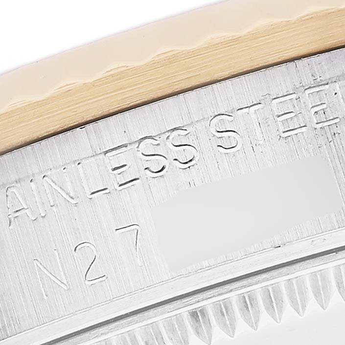 The image shows a close-up of the bezel and casing of a mid-size Rolex watch.