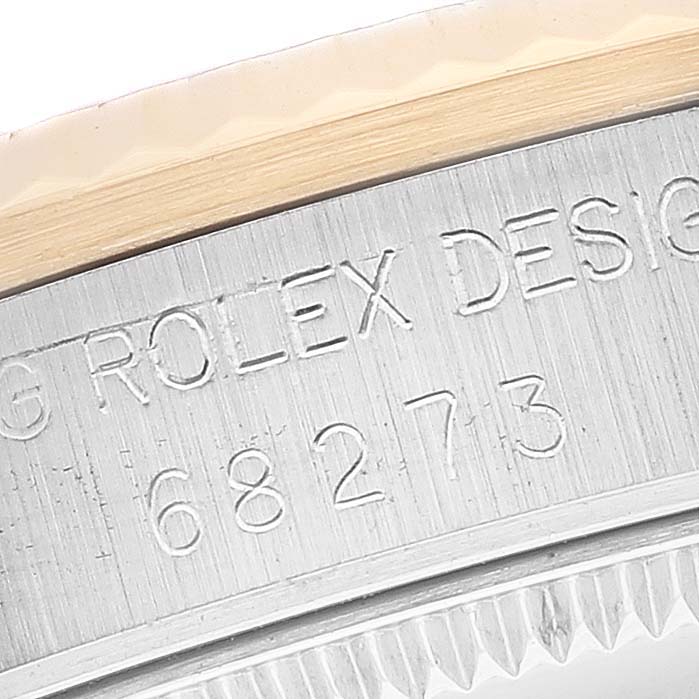 This close-up shows the engraving on the case side of a Mid-Size Rolex watch, including the model number and brand.