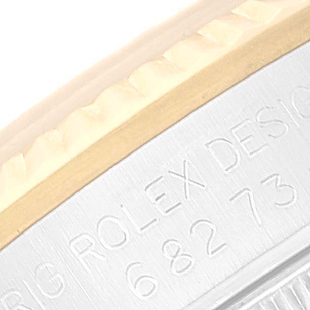 The image shows a close-up of the bezel and engraved side of a Mid-Size Rolex watch.