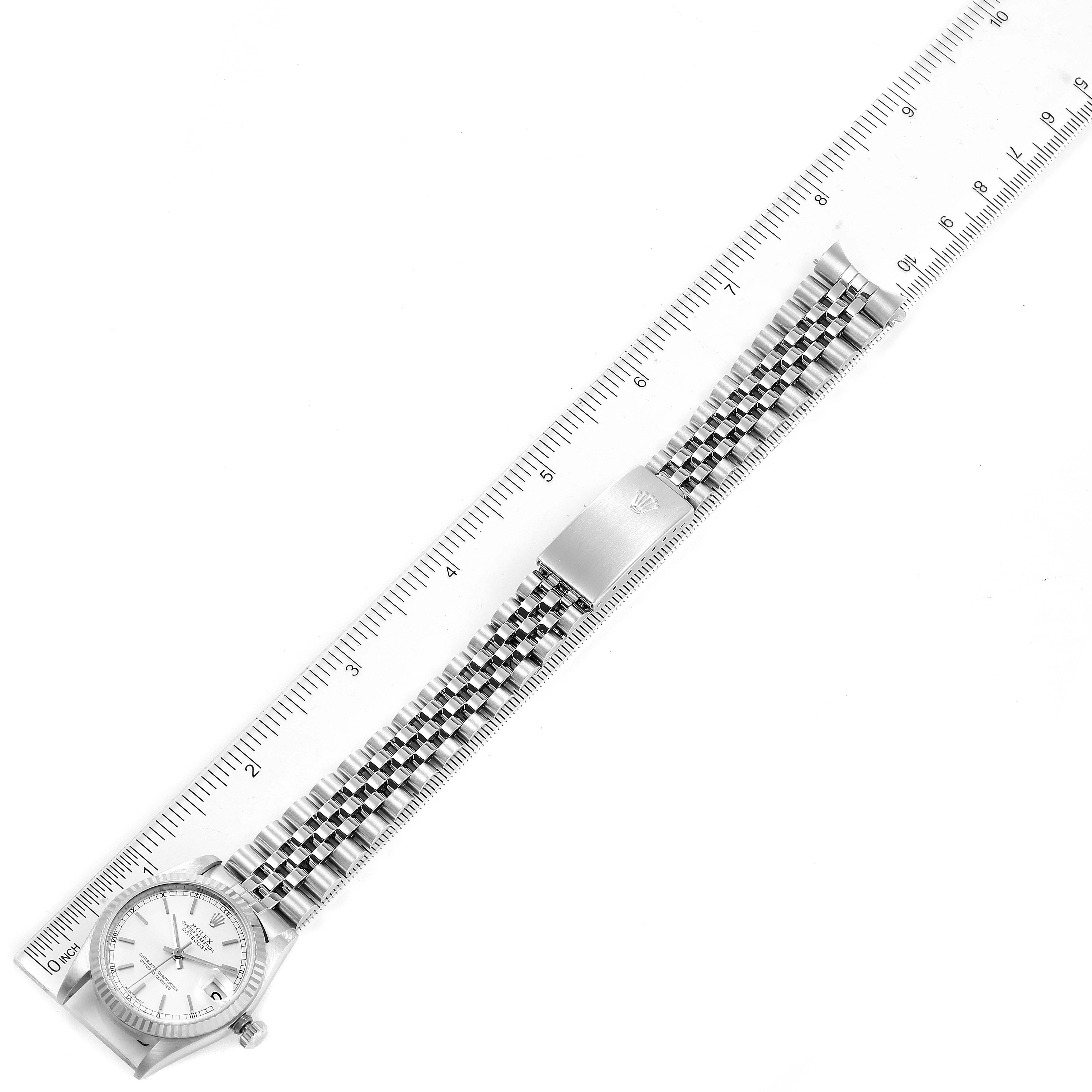 The image shows a top-down view of a Mid-Size Rolex watch with a metal bracelet measured against a ruler.