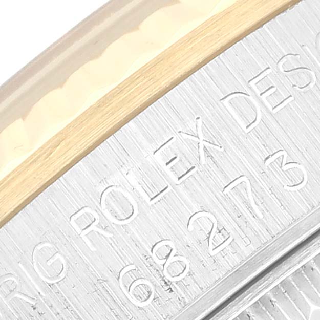 Close-up of the bezel and engraved markings on a Mid-Size Rolex watch.