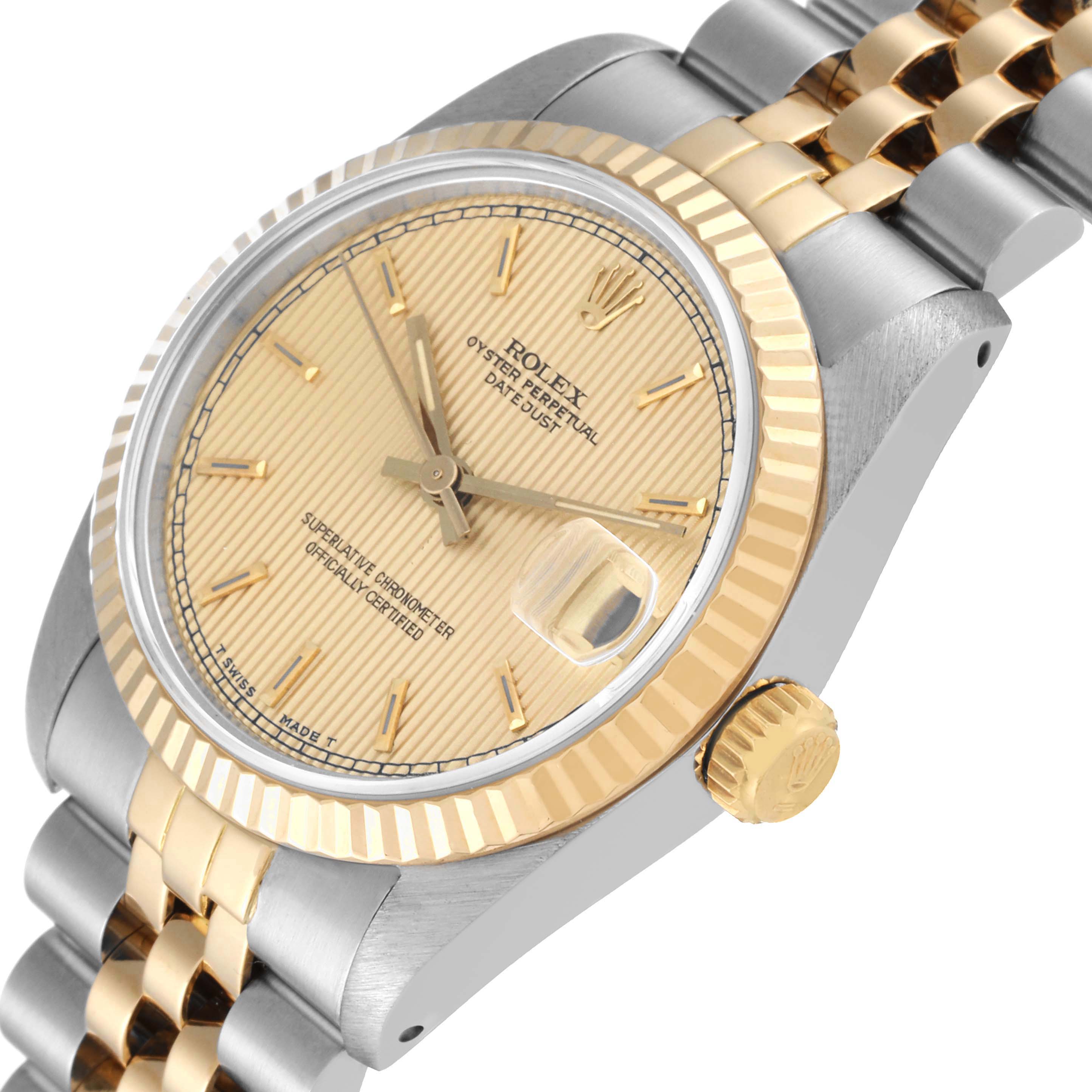 The image shows a close-up, side angle of a Rolex Mid-Size 68273 Women's Steel and Gold (two tone) Champagne Dial 68273 Women's Steel and Gold (two tone) Champagne Dial model watch displaying the dial, bezel, and part of the bracelet.