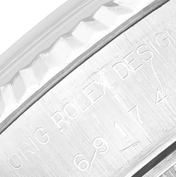 The image shows a close-up of the engraved side part of a Rolex Datejust 69174 Women's Stainless Steel Black Dial 69174 Women's Stainless Steel Black Dial watch, including part of the bezel.