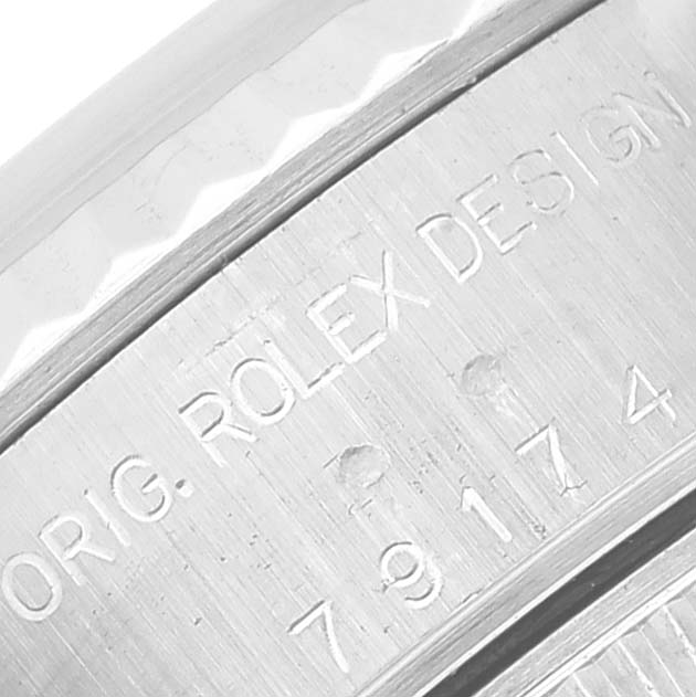 This close-up image shows the engraved bezel of a Rolex Datejust 79174 Women's Stainless Steel Silver Dial 79174 Women's Stainless Steel Silver Dial watch.