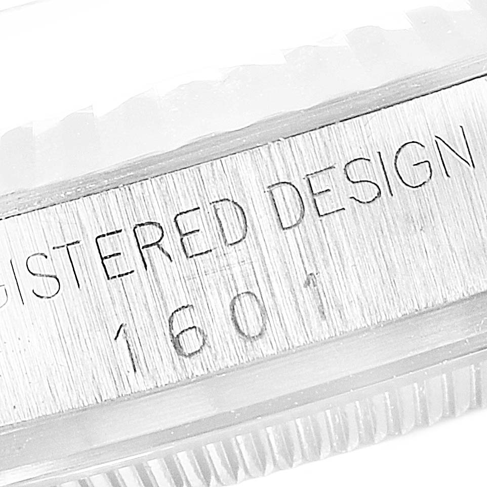 The image shows a close-up of the side view of the Rolex Vintage Collection 1601 Men's Stainless Steel Silver Dial 1601 Men's Stainless Steel Silver Dial model, highlighting the engraved "REGISTERED DESIGN 1601."