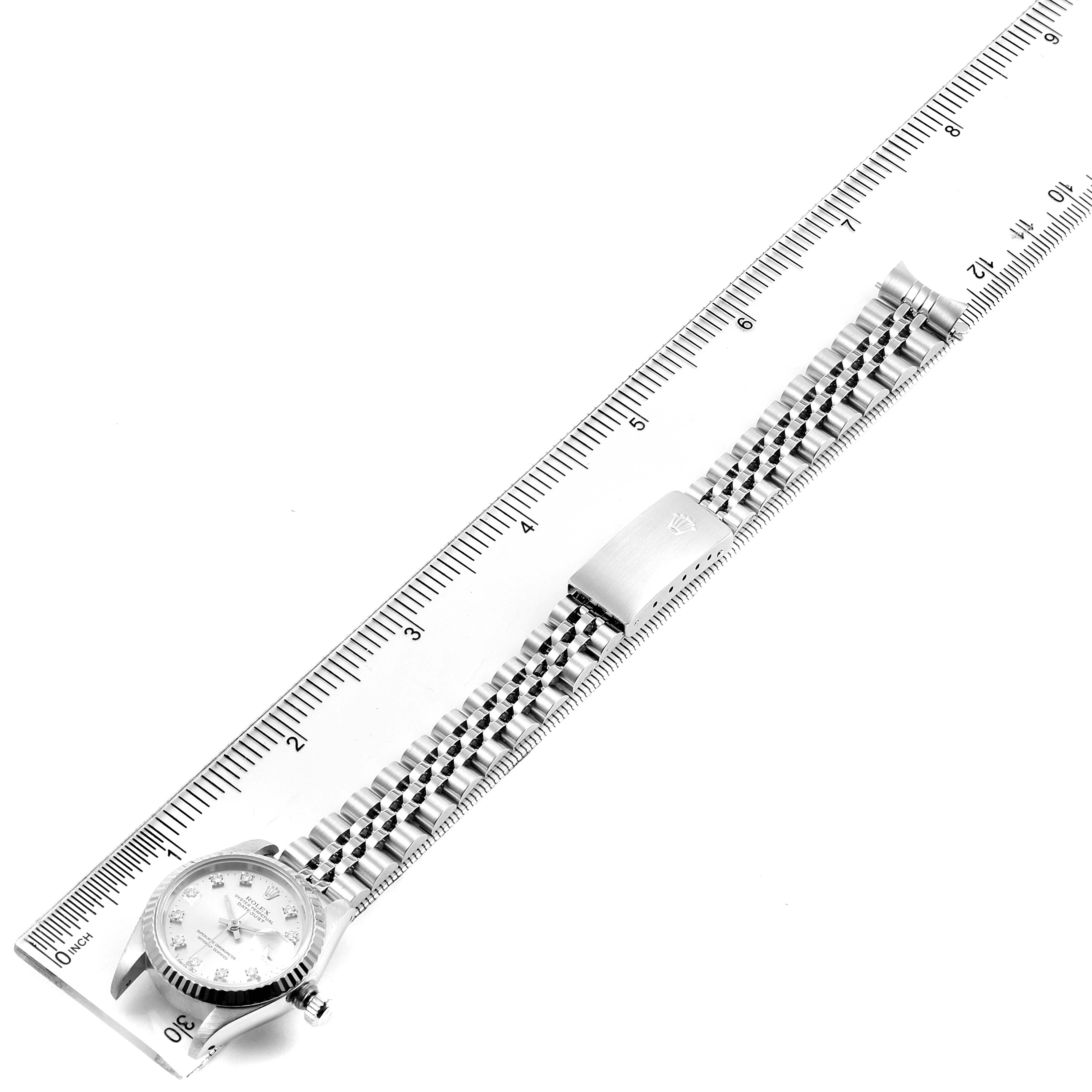 The image shows a Rolex Datejust 69174 Women's Stainless Steel Silver Dial 69174 Women's Stainless Steel Silver Dial watch with a stainless steel band, lying flat next to a ruler for measurement.
