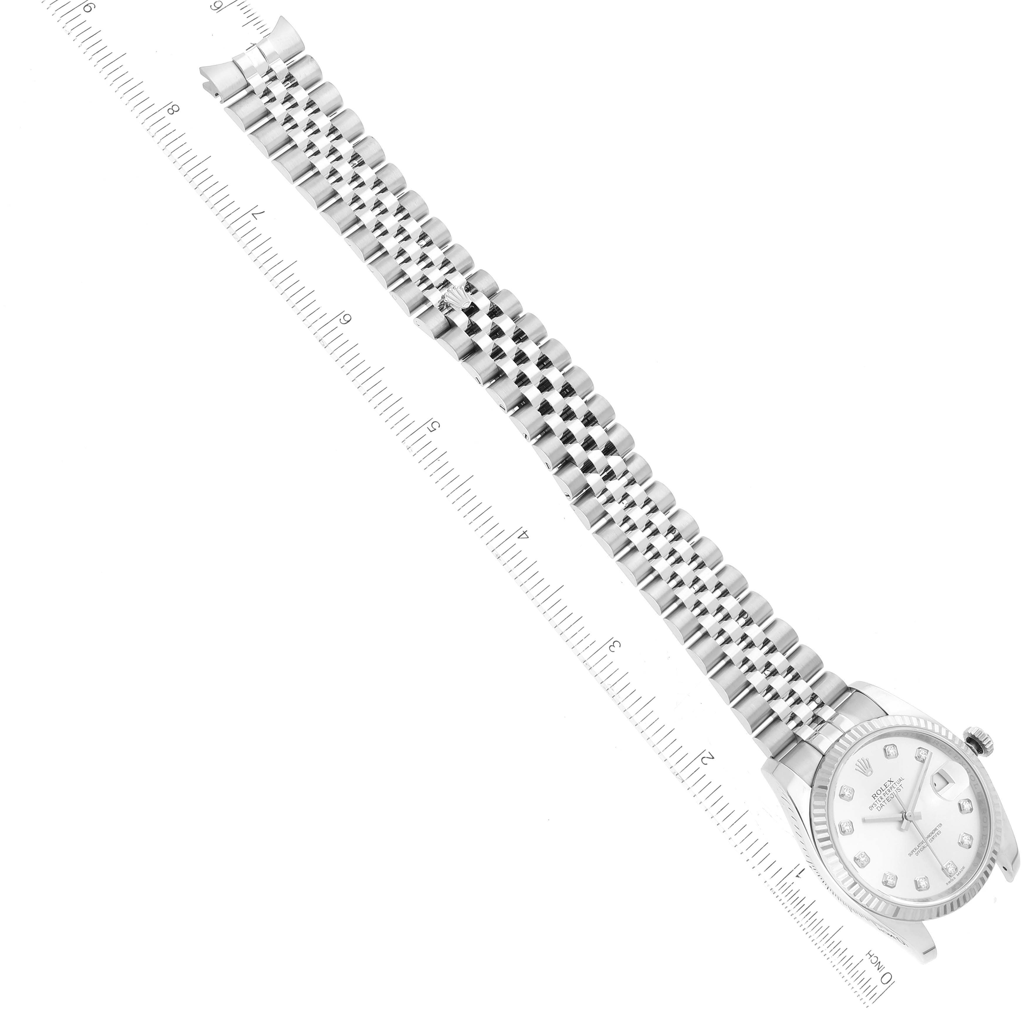 The image shows a Rolex Datejust 116234 Men's Stainless Steel Silver Dial 116234 Men's Stainless Steel Silver Dial watch at an oblique angle, highlighting the face, bezel, and metal bracelet alongside a measuring ruler.