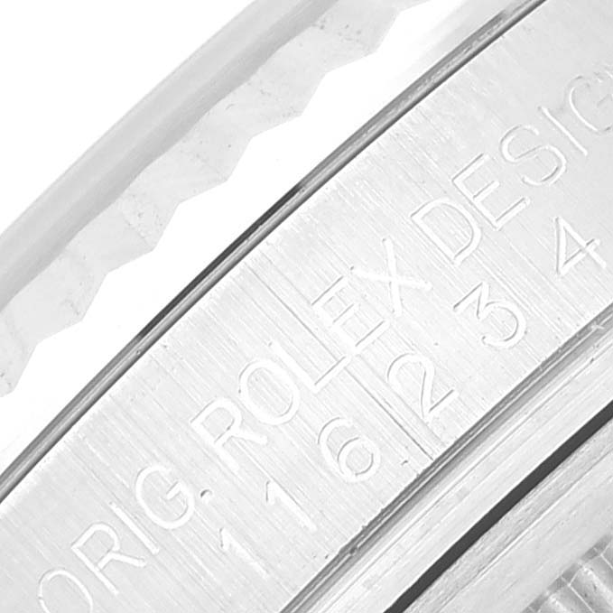 The image shows a close-up of the engraved inner rim of the bezel of a Rolex Datejust 116234 Men's Stainless Steel Silver Dial 116234 Men's Stainless Steel Silver Dial watch.