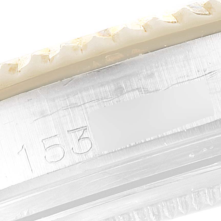 This image shows a close-up of the case edge and bezel of a Rolex Vintage Collection 1601 Men's Steel and Gold (two tone) Blue Dial 1601 Men's Steel and Gold (two tone) Blue Dial model, highlighting part of the engraved serial number.