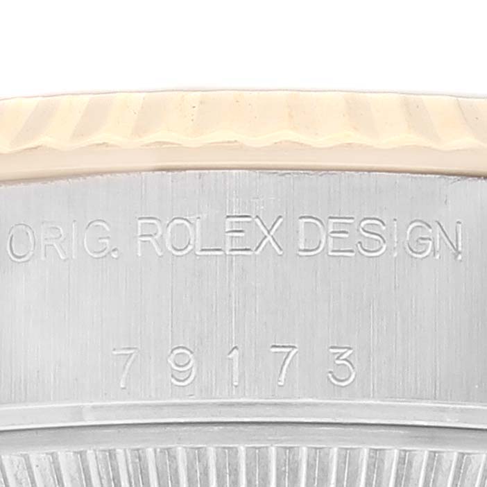 The image shows a close-up of the case side of a Rolex Datejust 79173 Women's Steel and Gold (two tone) Champagne Dial 79173 Women's Steel and Gold (two tone) Champagne Dial watch, showing the engraving "ORIG. ROLEX DESIGN 79173."