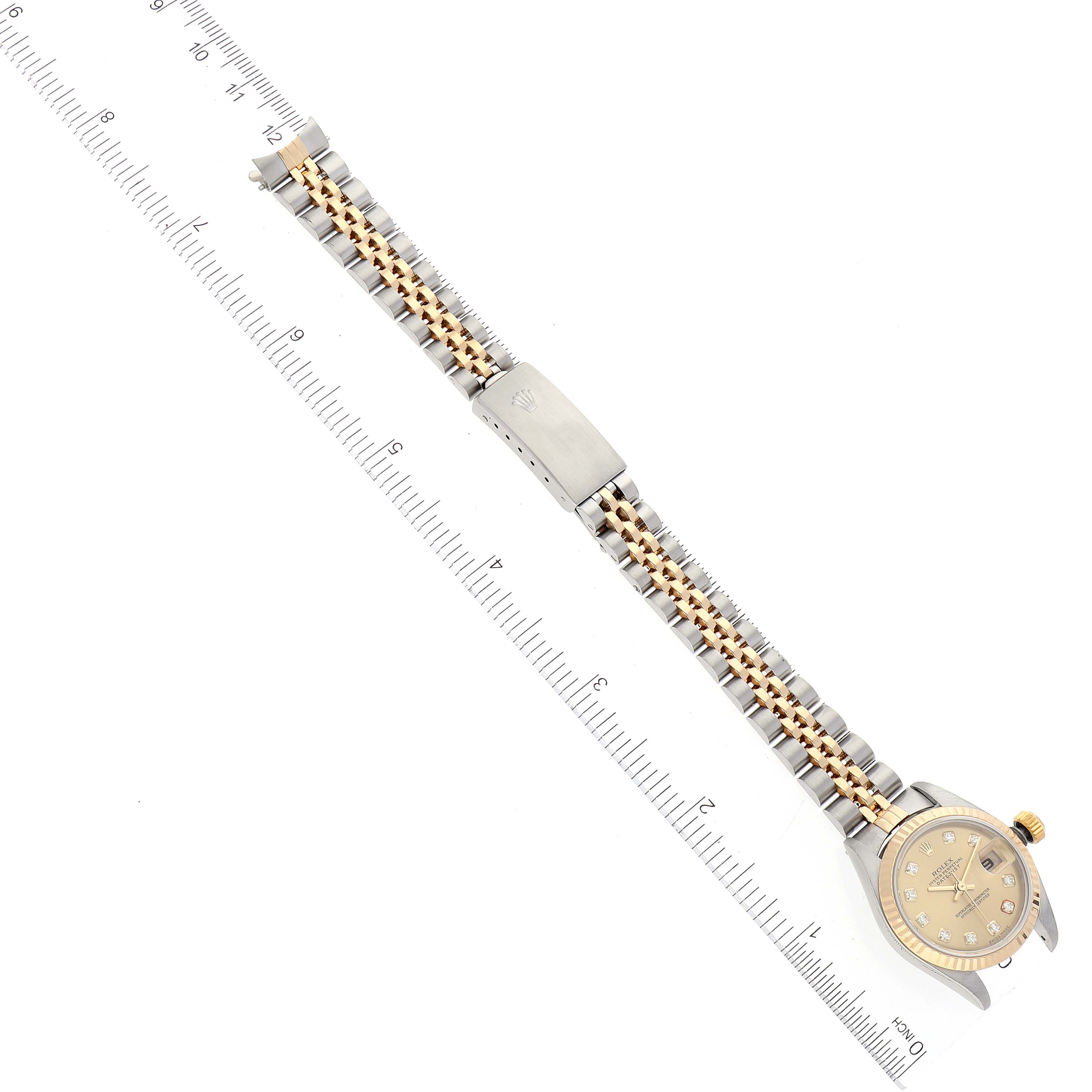 The image shows a Rolex Datejust 79173 Women's Steel and Gold (two tone) Champagne Dial 79173 Women's Steel and Gold (two tone) Champagne Dial watch from a top-down angle, highlighting the face, clasp, and two-tone bracelet.